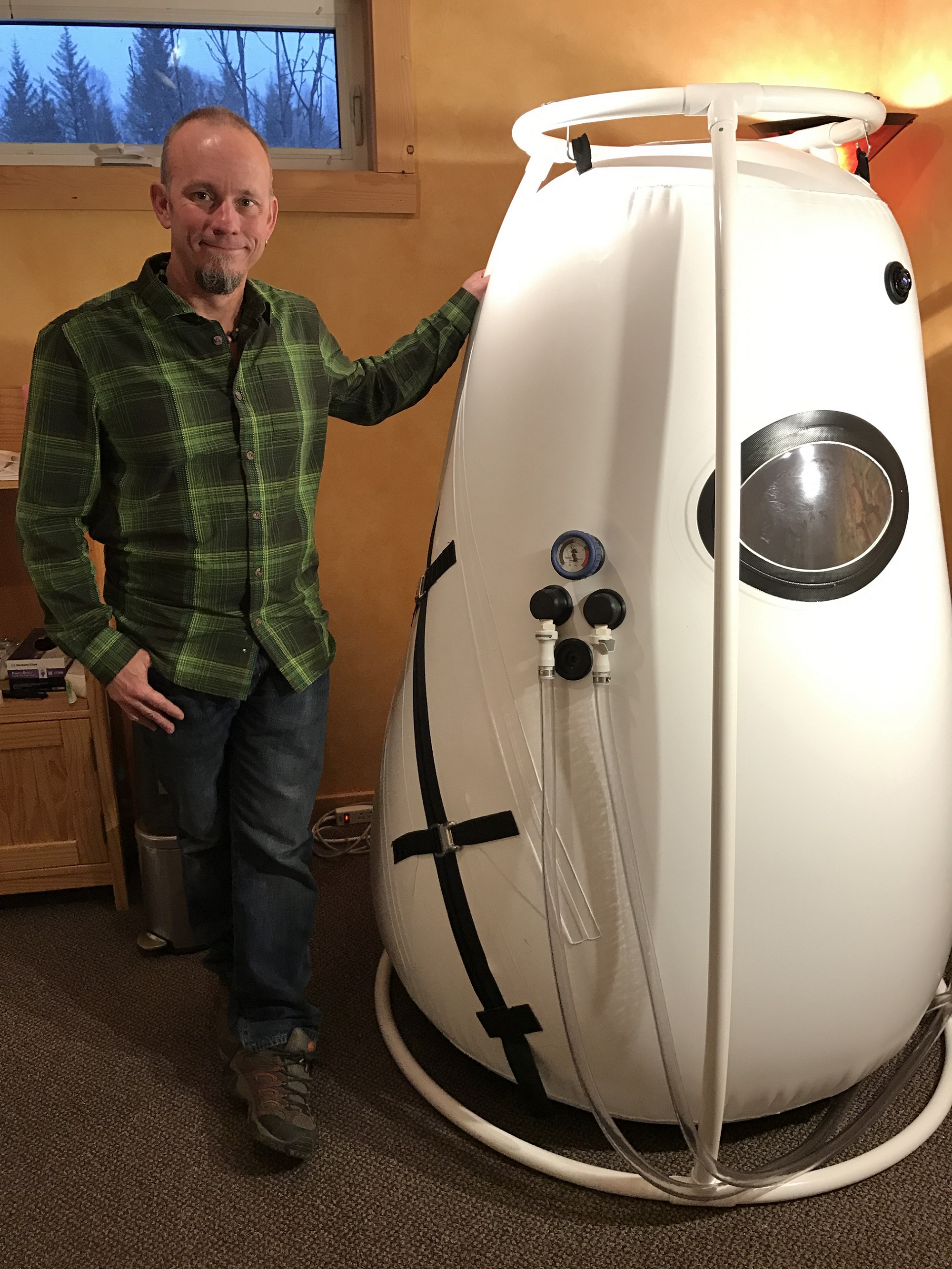 Dr. Patrick Huffman stands by the low-pressure hyperbaric oxygen tank that he recently acquired for his Frontier Natural Health office in Homer.-Photo provided