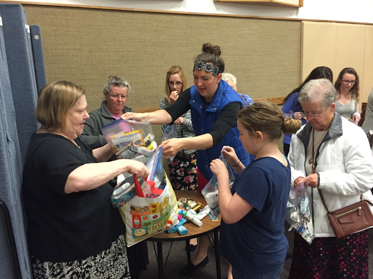 Jennadean Bateman helps fills "Blessing Bags" with items to donate to homeless teens at The Church of Jesus Christ of Latter-day Saints in Homer in September.-photo provided
