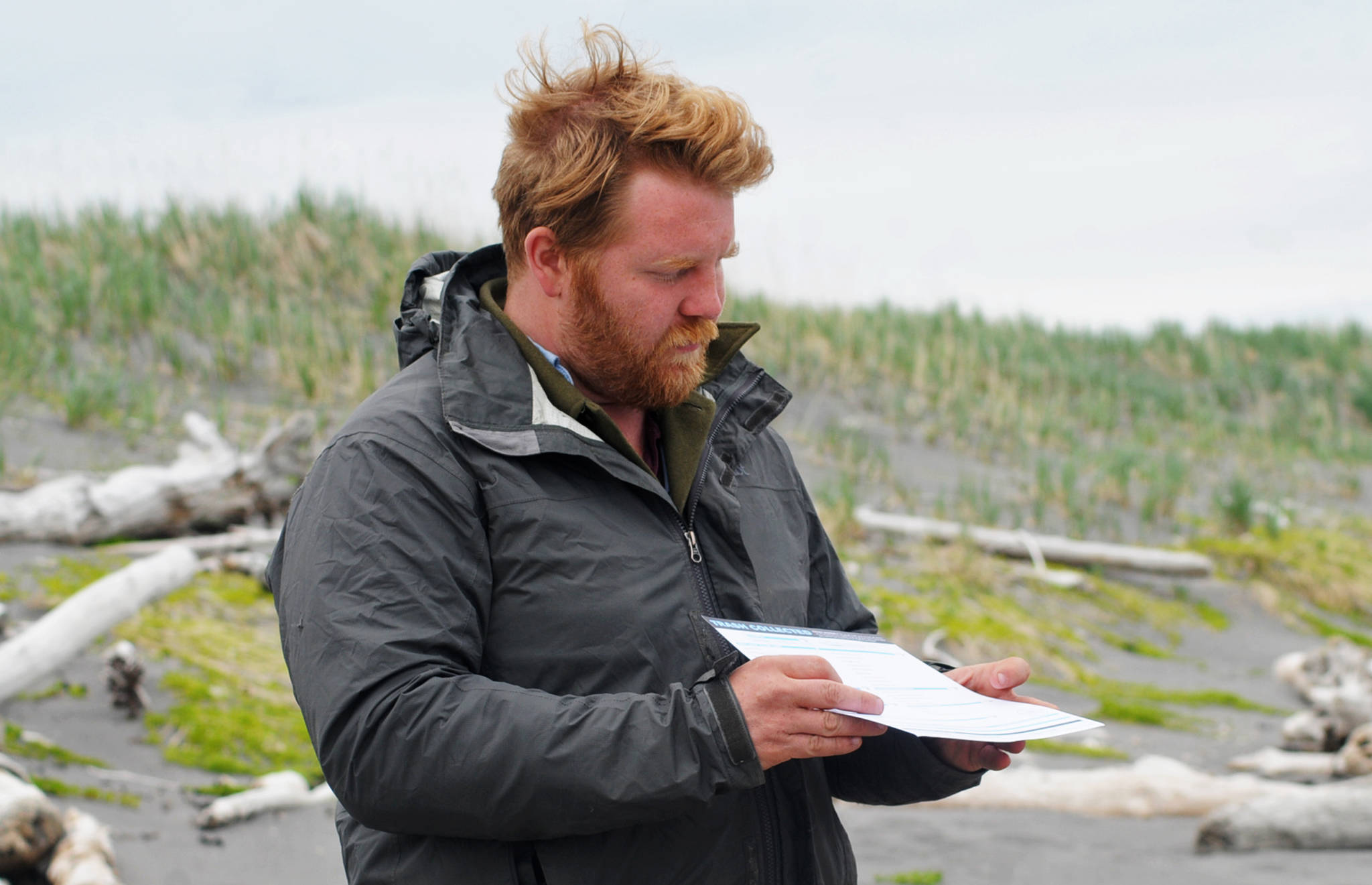 Henry Rieske, the environmental educator and coastwalk coordinator with the Homer-based Center for Alaskan Coastal Studies, explains an International Coastal Cleanup data sheet before sending groups out to gather marine debris from the beach on Sunday, June 3, 2017 on Augustine Island, Alaska. The center coordinated a trip to the island to clean up trash from the beaches of the remote island in Cook Inlet. (Elizabeth Earl/Peninsula Clarion)  Henry Rieske, the environmental educator and coastwalk coordinator with the Homer-based Center for Alaskan Coastal Studies, explains an International Coastal Cleanup data sheet before sending groups out to gather marine debris from the beach on Sunday on Augustine Island. The center coordinated a trip to the island to clean up trash from the beaches of the remote island in Cook Inlet. (Elizabeth Earl/Peninsula Clarion)