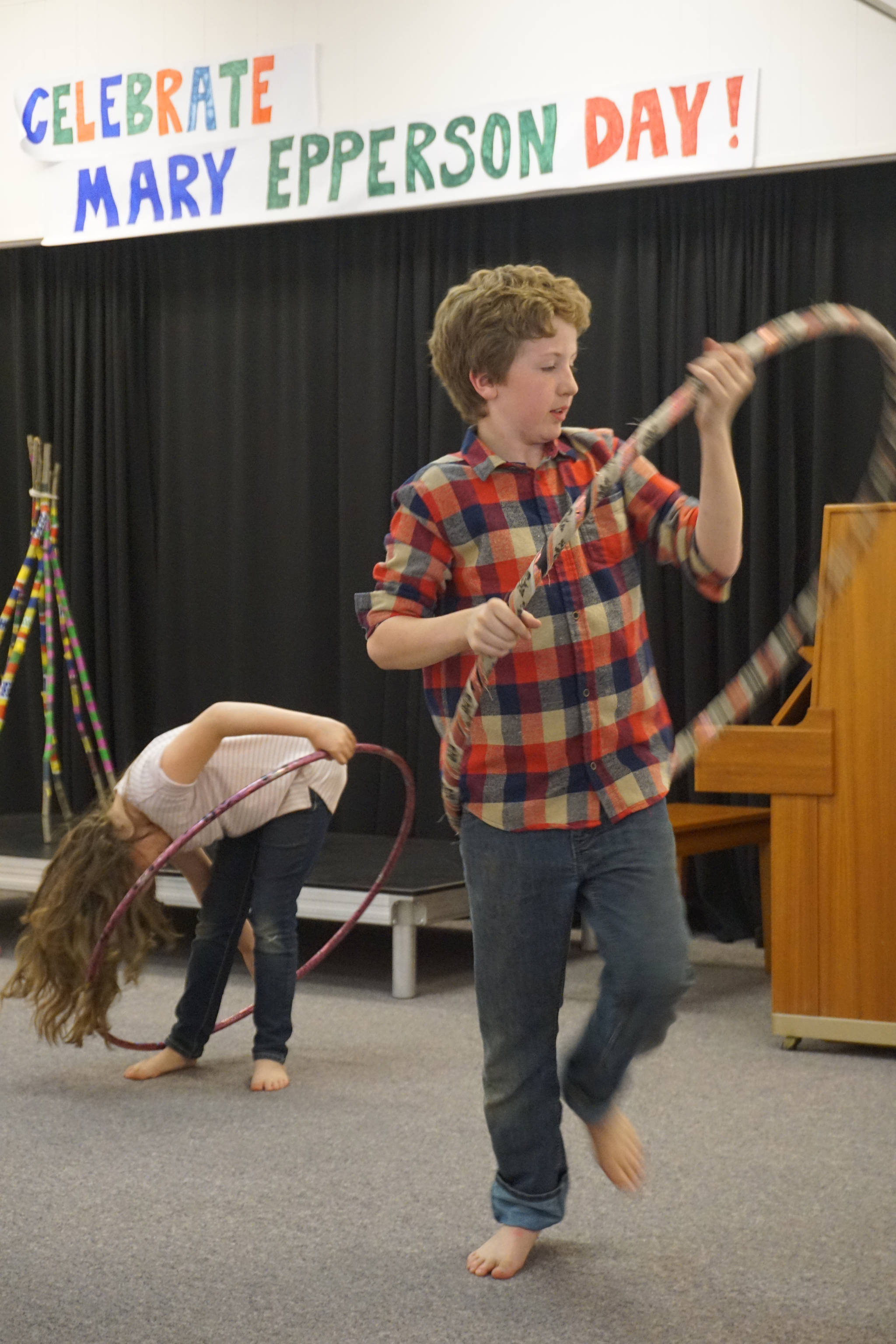 Will Bradshaw, center, and Grace Bradshaw, left, spin hoops for Mary Epperson Day on Tuesday, June 6, at the Homer Council on the Arts. The event was a fundraiser to raise the final $50,000 of the project.
