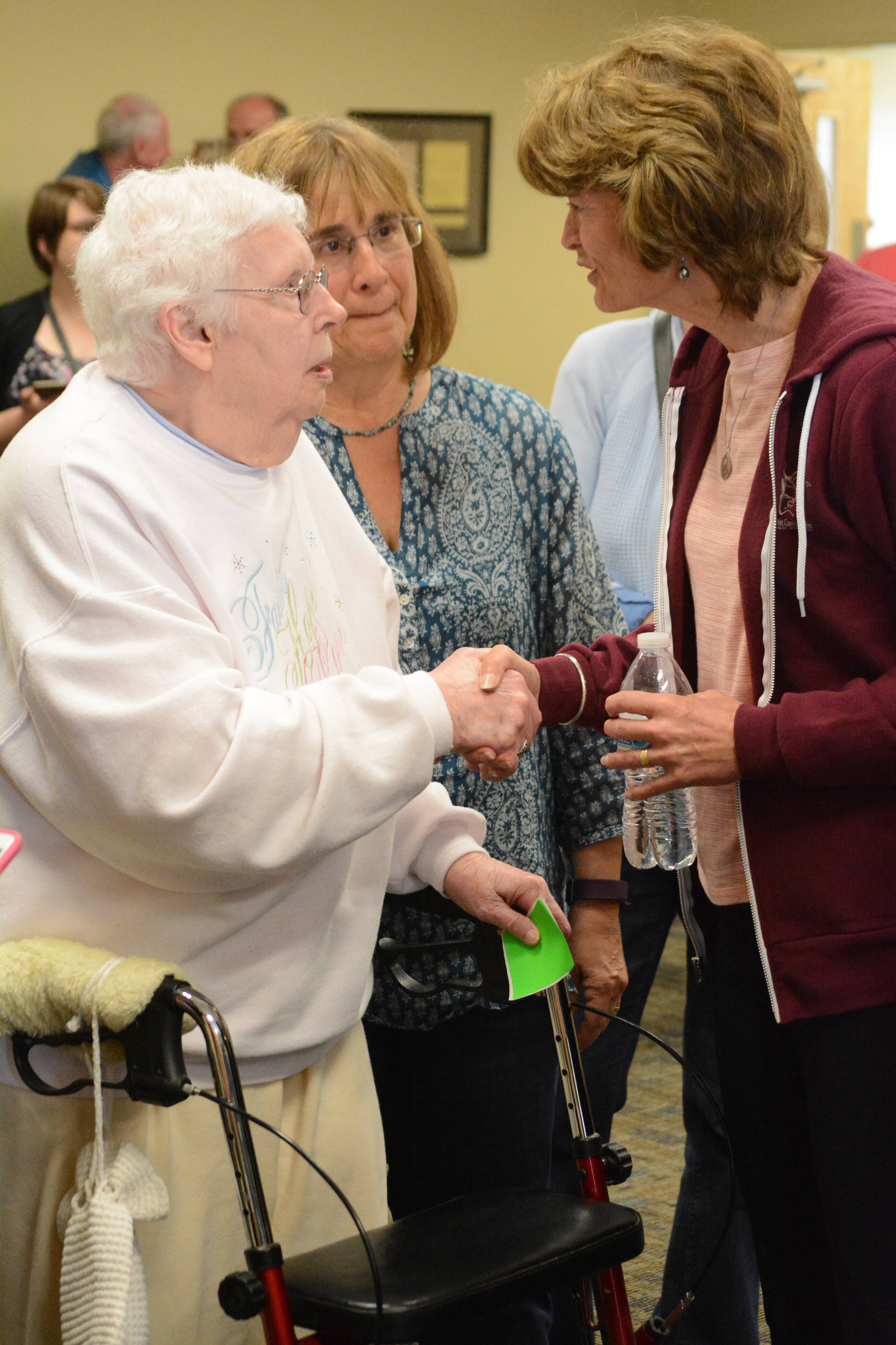 Sen. Lisa Murkowski, R-Alaska, right, visits with retired nurse Mary Raymond, left, as Mary Fries, center, also a nurse, listens. Murkowski spoke at town hall meeting on health care Friday, July 7, 2017, at Homer City Hall. About 150 people packed the Cowles Council Chambers to share their concerns about health care.
