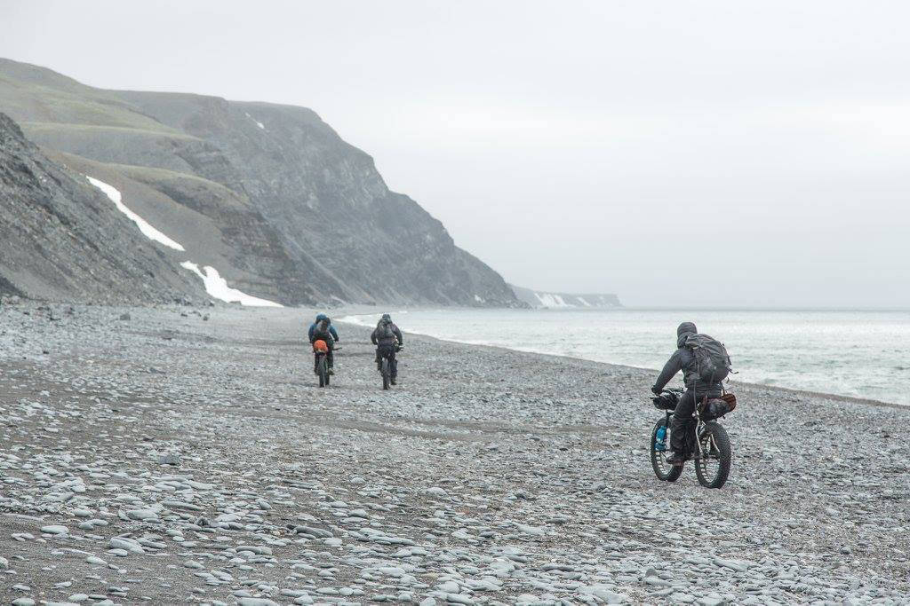The Roof of the Arctic group bikes along the beach before heading inland to the Lisburne Hills. They had to backtrack after setting up their camp earlier. (Photo courtesy Bjørn Olson)