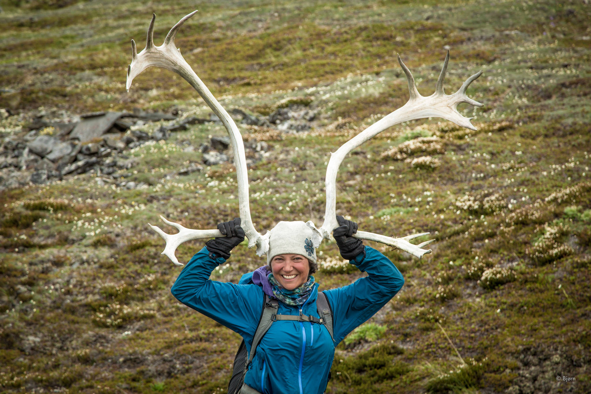 Alayne Tetor holds up a pair of caribou antlers. (Photo courtesy Bjørn Olson)