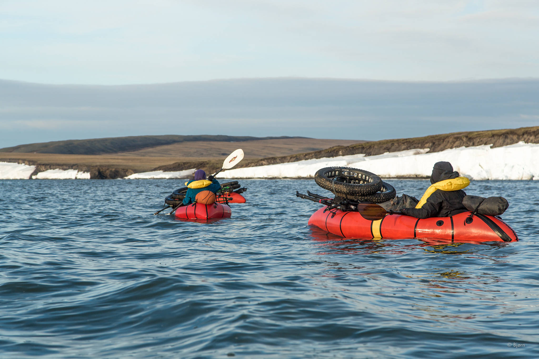 Along sectins of the coast where snow drifts clogged the beach, the Roof of the Arctic group had to paddle in pack rafts around the barriers. (Photo courtesy Bjørn Olson)