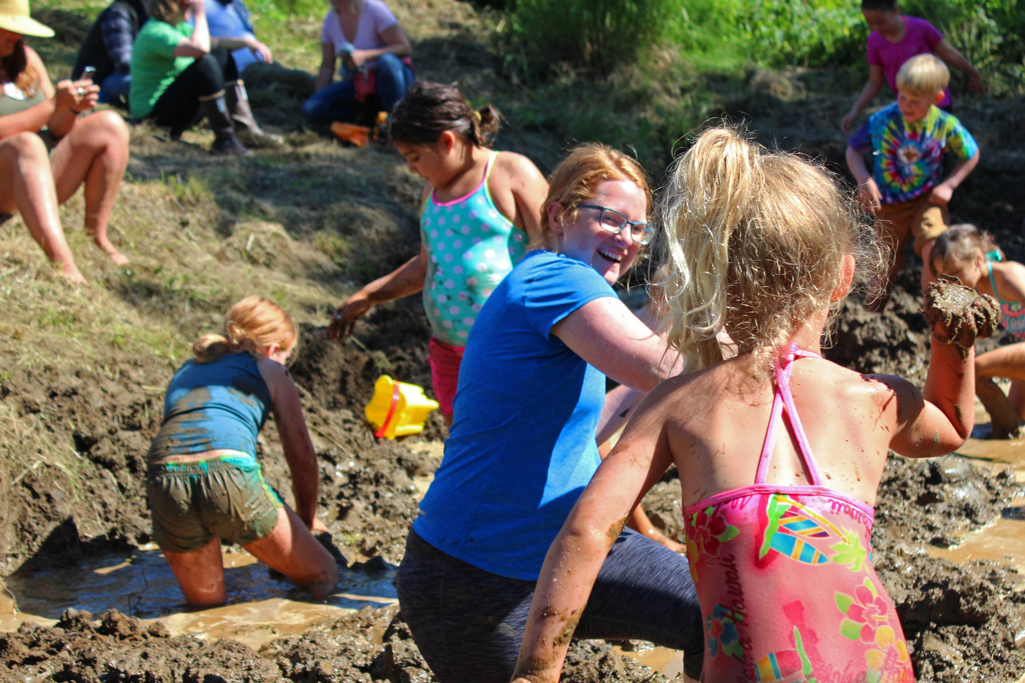 Photo by Megan Pacer/Homer News Lisa Asselin, background, laughs as she braces herself for a handful of mud about to be flung by Isla Brown, 4, during this year’s Mud Wallow on Saturday, July 22, 2017 at Cottonwood Horse Park in Homer, Alaska. Asselin was one of the event’s coordinators.