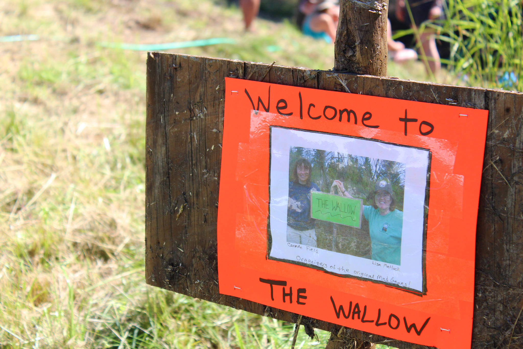 Photo by Megan Pacer/Homer News A sign depicting Mud Wallow co-founders Lisa Matlock and the late Carmen Field during welcomes the young and old to this year’s Mud Wallow on Saturday, July 22, 2017 at Cottonwood Horse Park in Homer, Alaska.