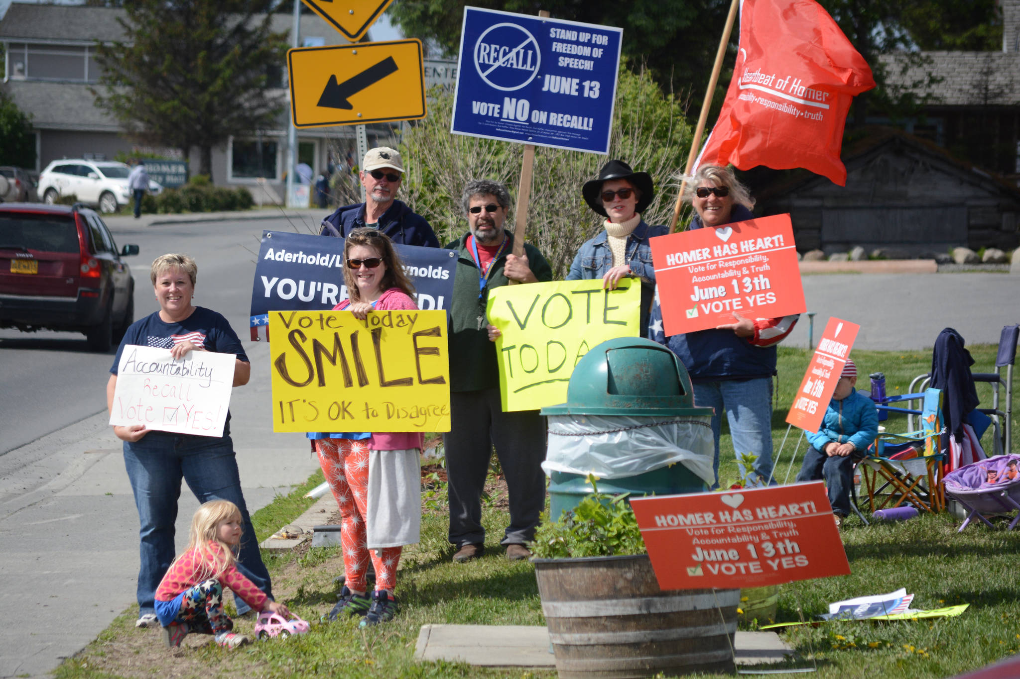 Recall opponent Alex Koplin, center, with blue sign, joins pro-recall supporters at WKFL Park about 11 a.m. Tuesday as citizens rallied on Pioneer Avenue to state their sides in the recall special election. (Photo by Michael Armstrong, Homer News)