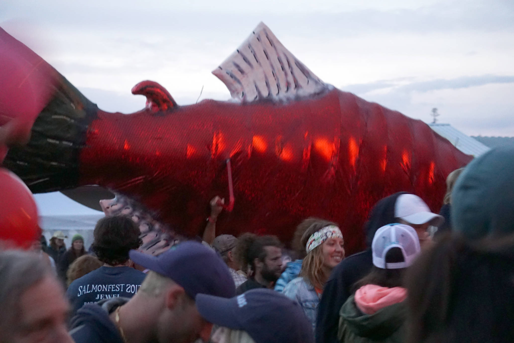 A giant salmon puppet swims through the crows as Rusted Root performs on Saturday night, Aug. 5, 2017, at Salmonfest, Ninilchik, Alaska.(Photo by Michael Armstrong, Homer News)