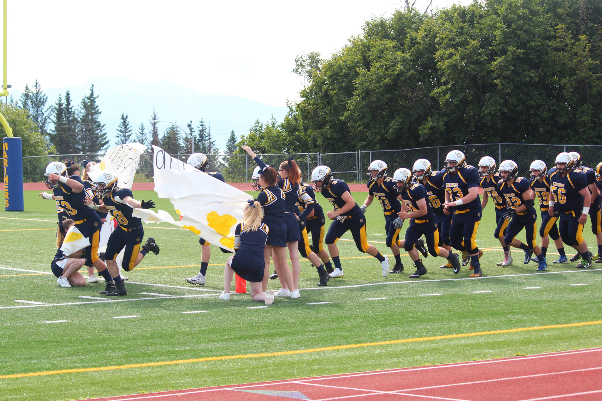 Members of the Homer Mariners varsity football team take the field for their game Saturday, Aug. 12, 2017 at Homer High School in Homer, Alaska. The Mariners lost to Kodiak 21-8. (Photo by Megan Pacer/Homer News)
