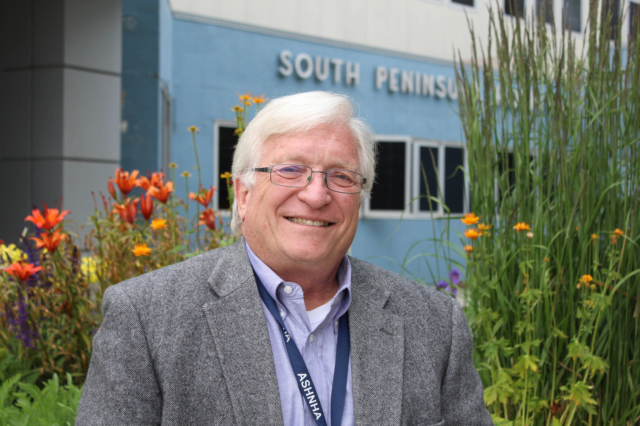 South Peninsula Hospital CEO Robert Letson poses for a photo in front of the hospital’s Bartlett Street entrance on July 9, 2016, for SPH’s 60th Anniversary Party. (Homer News file photo, Anna Frost)