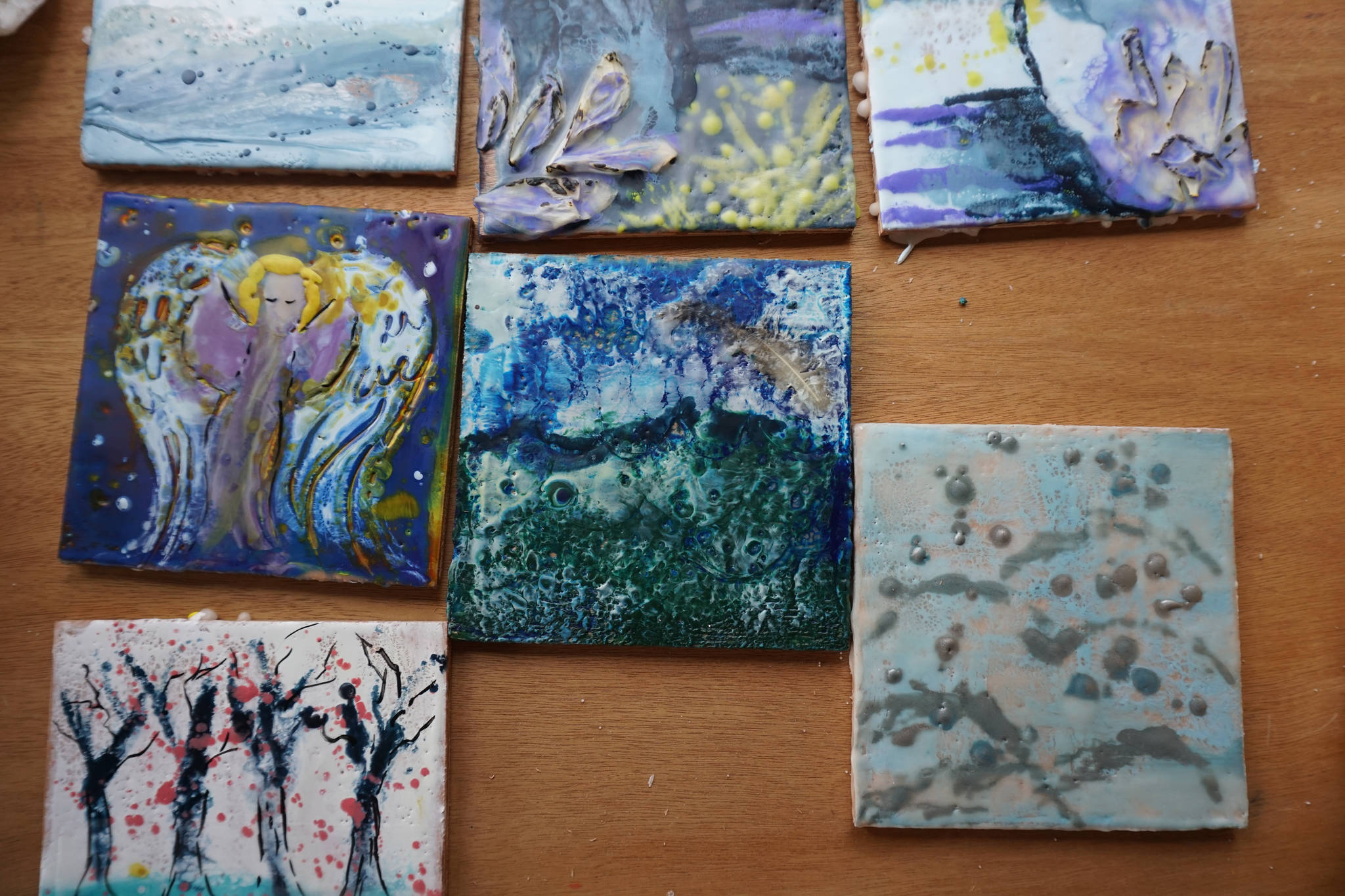 Some of the encaustic art created in Ann-Margret Wimmerstedts Wax. Wine & Wimmerstedt class held July 30, 2017 at Wimmerstedt’s home. (Photo by Michael Armstrong/Homer News)
