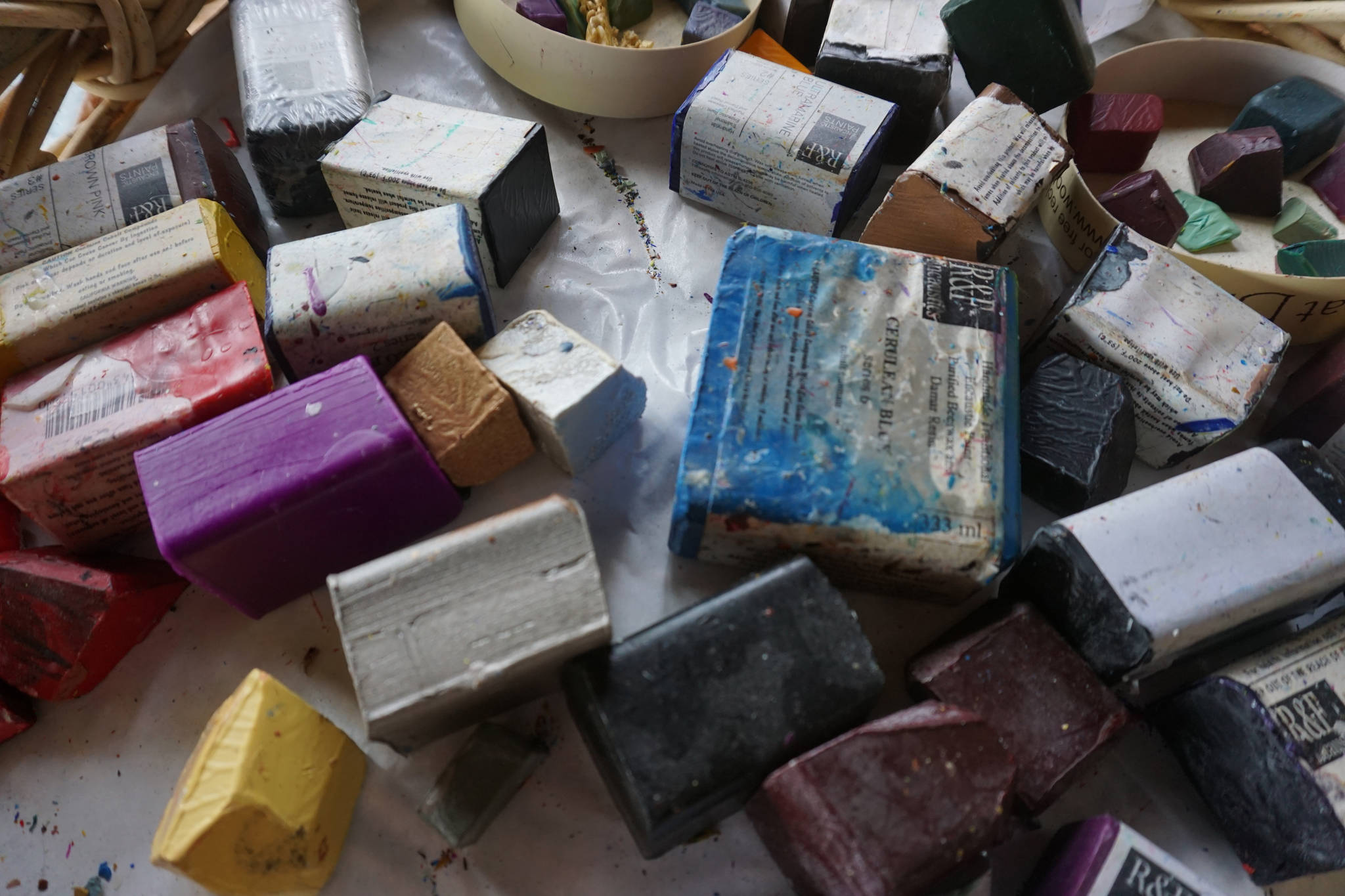 Blocks of encaustic paints fill up a basket at Ann-Margret Wimmerstedt’s encaustic workshop on July 30, 2017. (Photo by Michael Armstrong/Homer News)