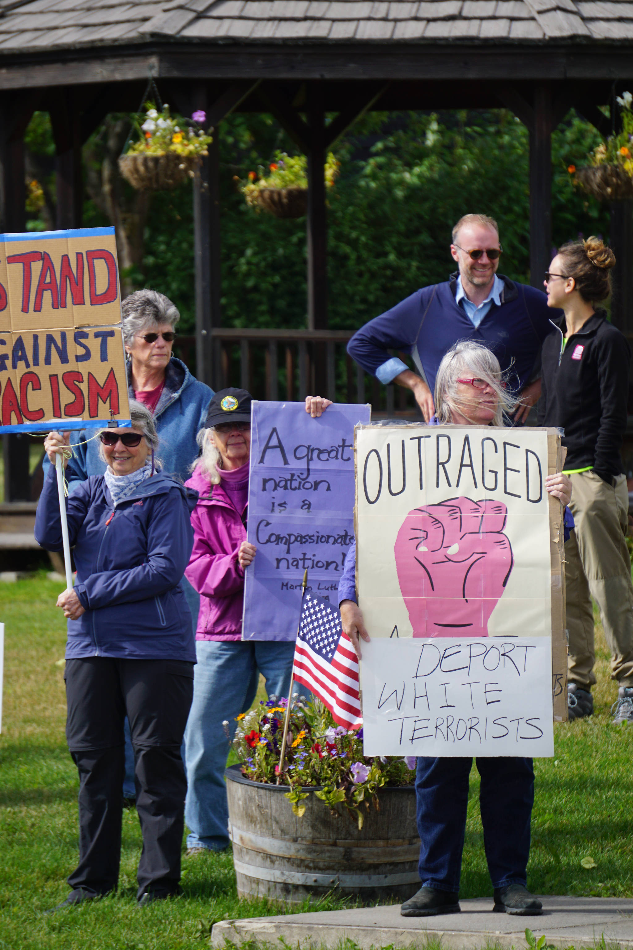 People demonstrating against the events of Charlottesville, Va., and other white supremacist rallies stand up against racism at WKFL Park in Homer on Sunday afternoon. About 50 people attended the one-hour event held from 3-4 p.m. Sunday, Aug. 13, 2017 in Homer, Alaska. (Photo by Michael Armstrong, Homer News)