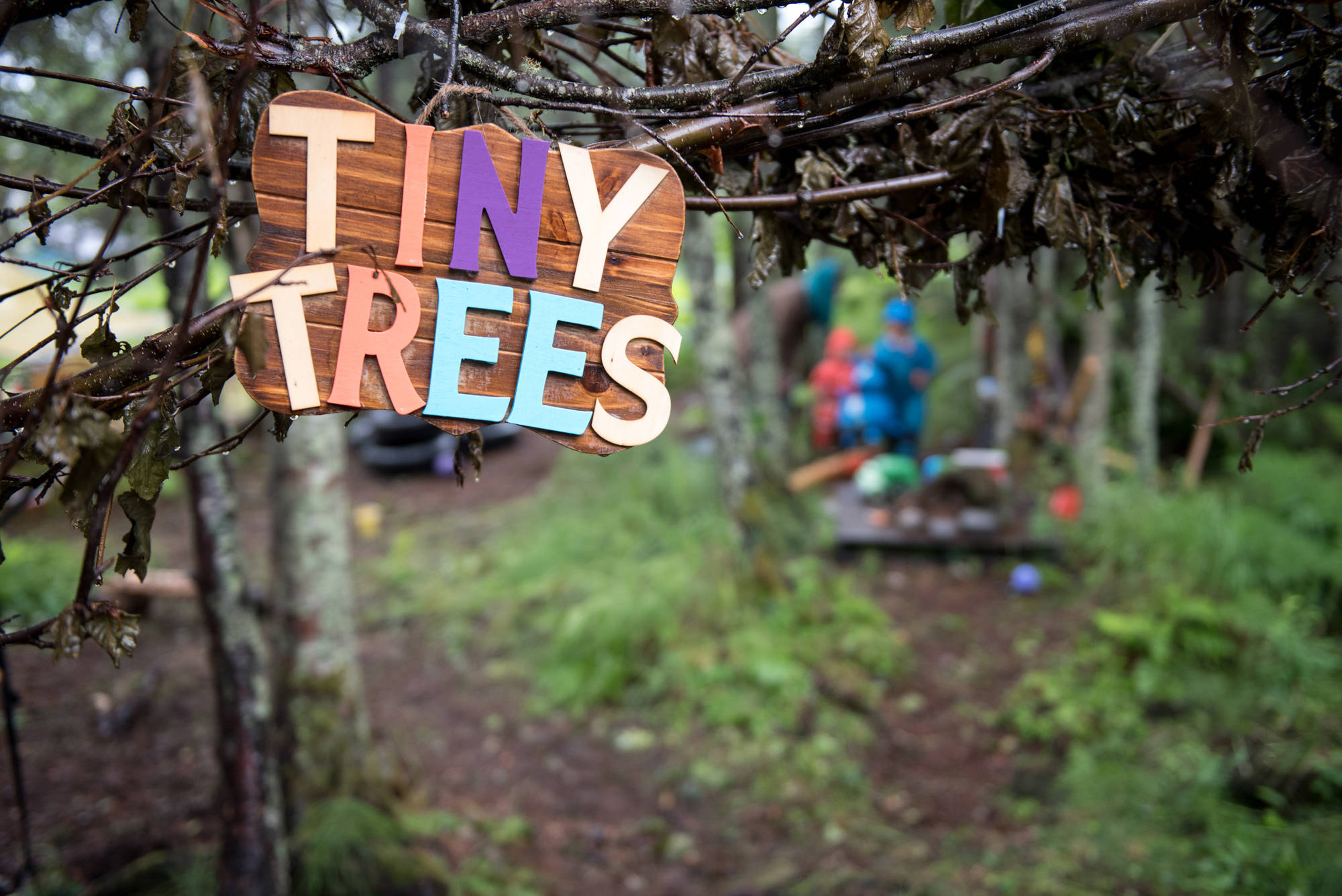 Children enrolled at Tiny Trees spend the majority of their day outdoors, engaged in intentionally set-up, play-based learning activities. If the weather is wet or cold, the children dress appropriately instead of staying indoors. (Photo by Scott Dickerson)