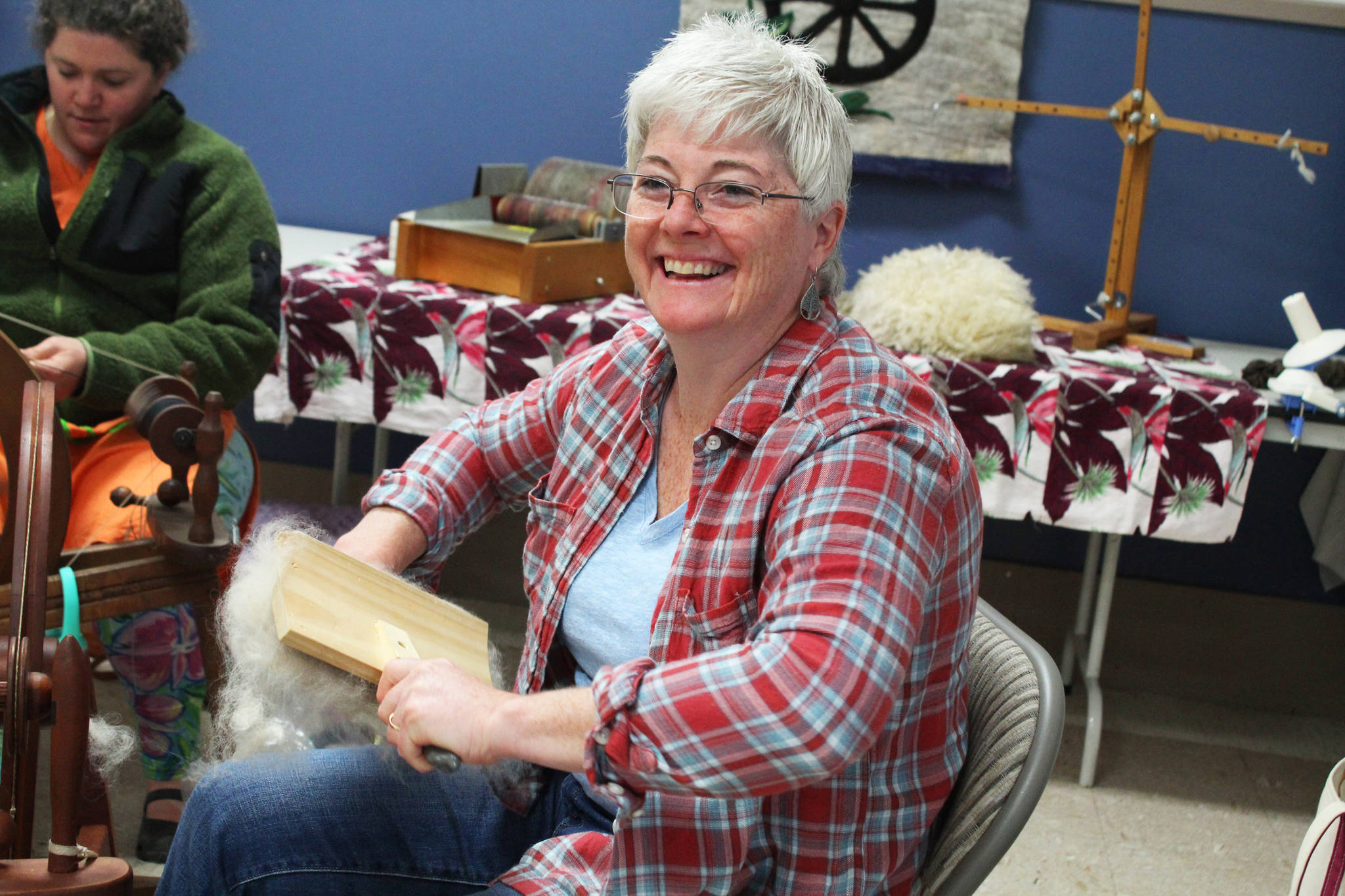 Karen Porter, a member of the Fireweed Fiber Guild, prepares some fibers while spinning yarn with other guild members Friday, Aug. 18, 2017 at this year’s Kenai Peninsula Fair in Ninilchik, Alaska. (Photo by Megan Pacer/Homer News)