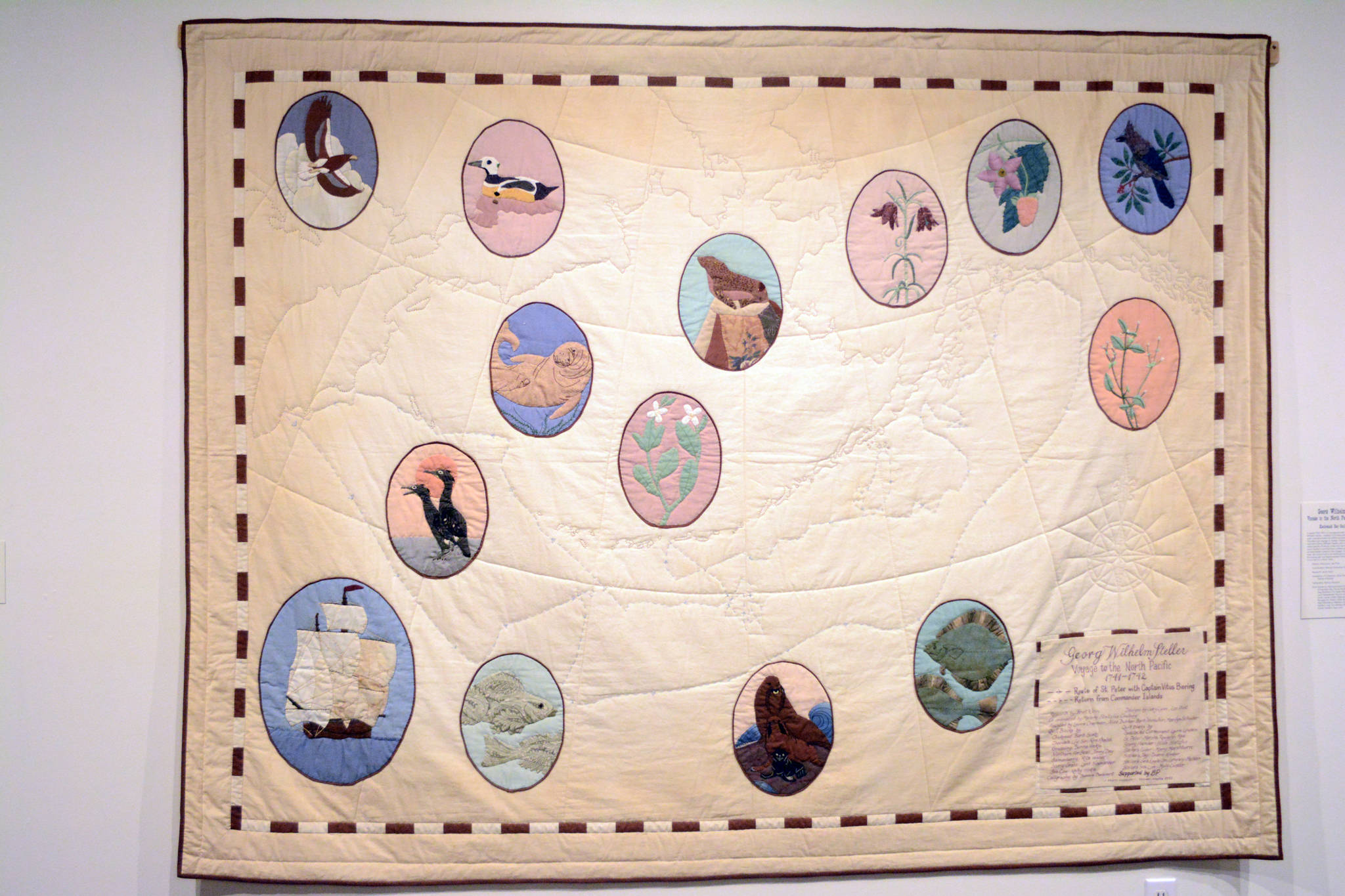 “Georg Wilhelm Steller: Voyage to the North Pacific 1741-42,” by the Kachemak Bay Quilters, done in 1991, commemorates the 250th anniversary of Bering’s voyage to Alaska that included Alaska’s first naturalist. Shown here Tuesday, Aug. 22, 2017, it shows the route of Bering’s voyage and the animals Steller first described. It’s part of the cARTography exhibit at the Pratt Museum, Homer, Alaska. (Photo by Michael Armstrong, Homer News)