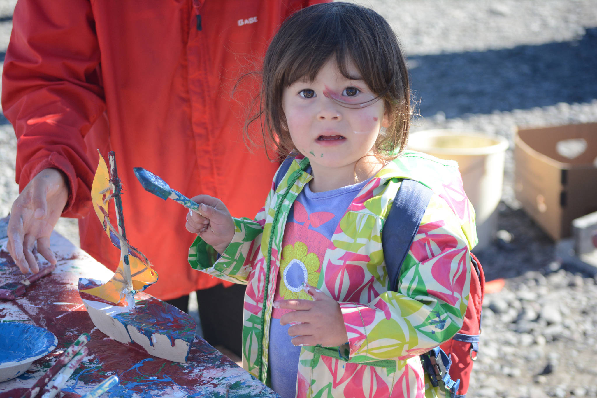 Sei Beams, 2, paints a wooden boat at a previous Kachemak Bay Wooden Boat Festival on the Spit. (Homer News file photo)