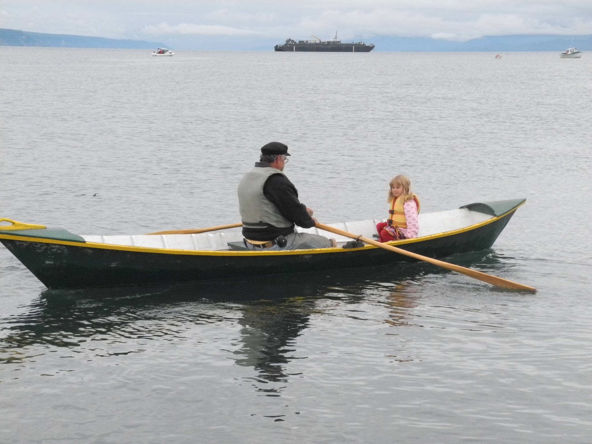 Bumppo Bremicker takes his granddaughter, Zoe Bremicker, for a ride at a previous Kachemak Bay Wooden Boat Festival. (Homer News file photo)