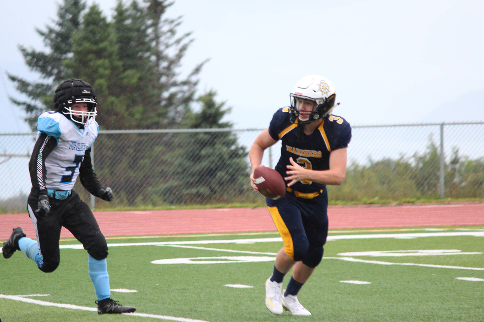 Senior Dawson Felde runs with the ball during Saturday’s game between the varsity Homer Mariners football and Valdez High School on Aug. 26, 2017 at the Mariner field in Homer, Alaska. Homer was victorious over Valdez 66-0. (Photo by Megan Pacer/Homer News)