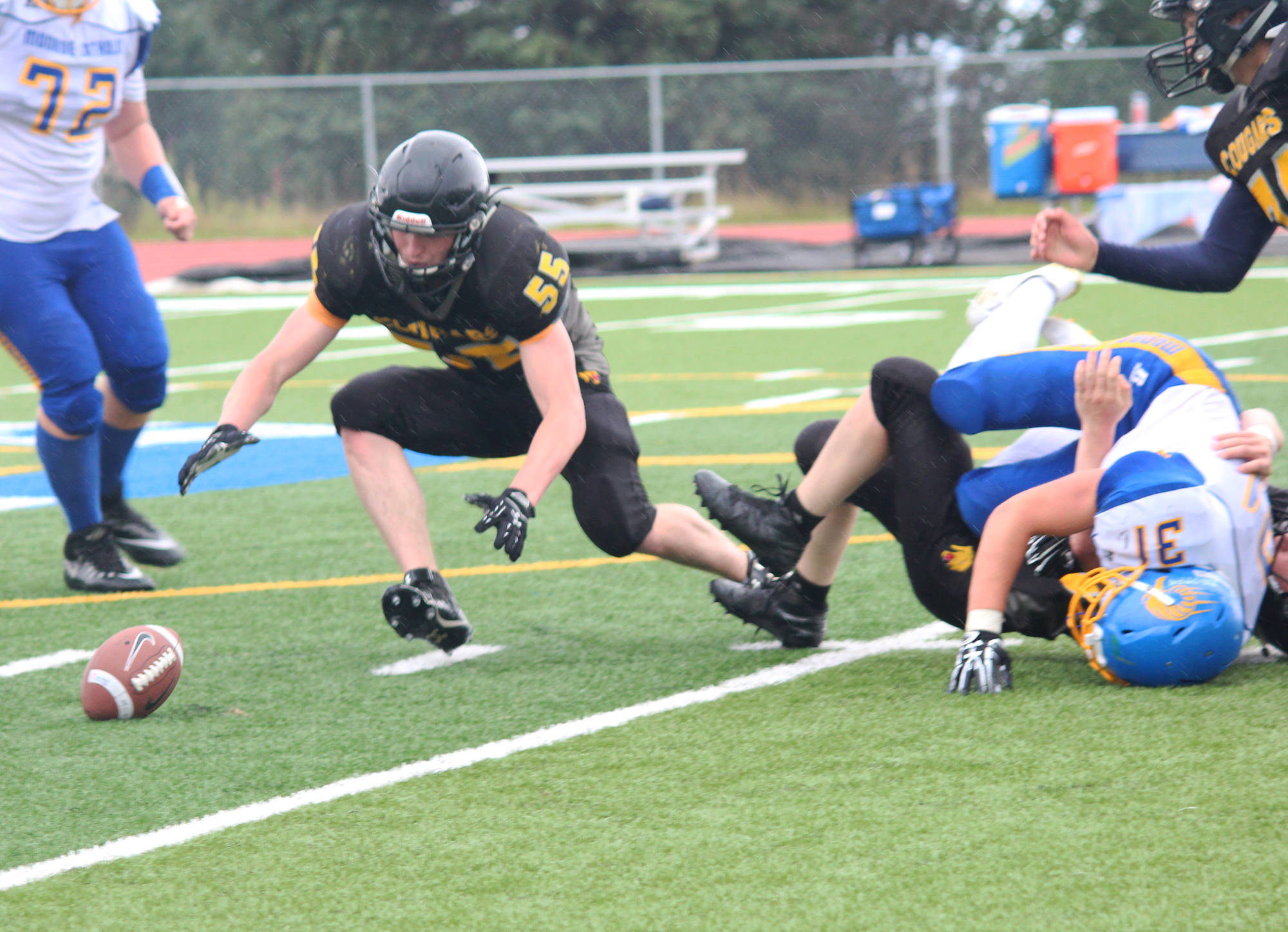 Offensive and defensive lineman Nikit Anufriev, a senior, dives for a fumbled ball during the Voznesenka Cougars’ game against Monroe Catholic High School on Saturday, Aug. 26, 2017 at the Homer Mariners’ field in Homer, Alaska. The Fairbanks team defeated Voznesenka 26-0. (Photo by Megan Pacer/Homer News)