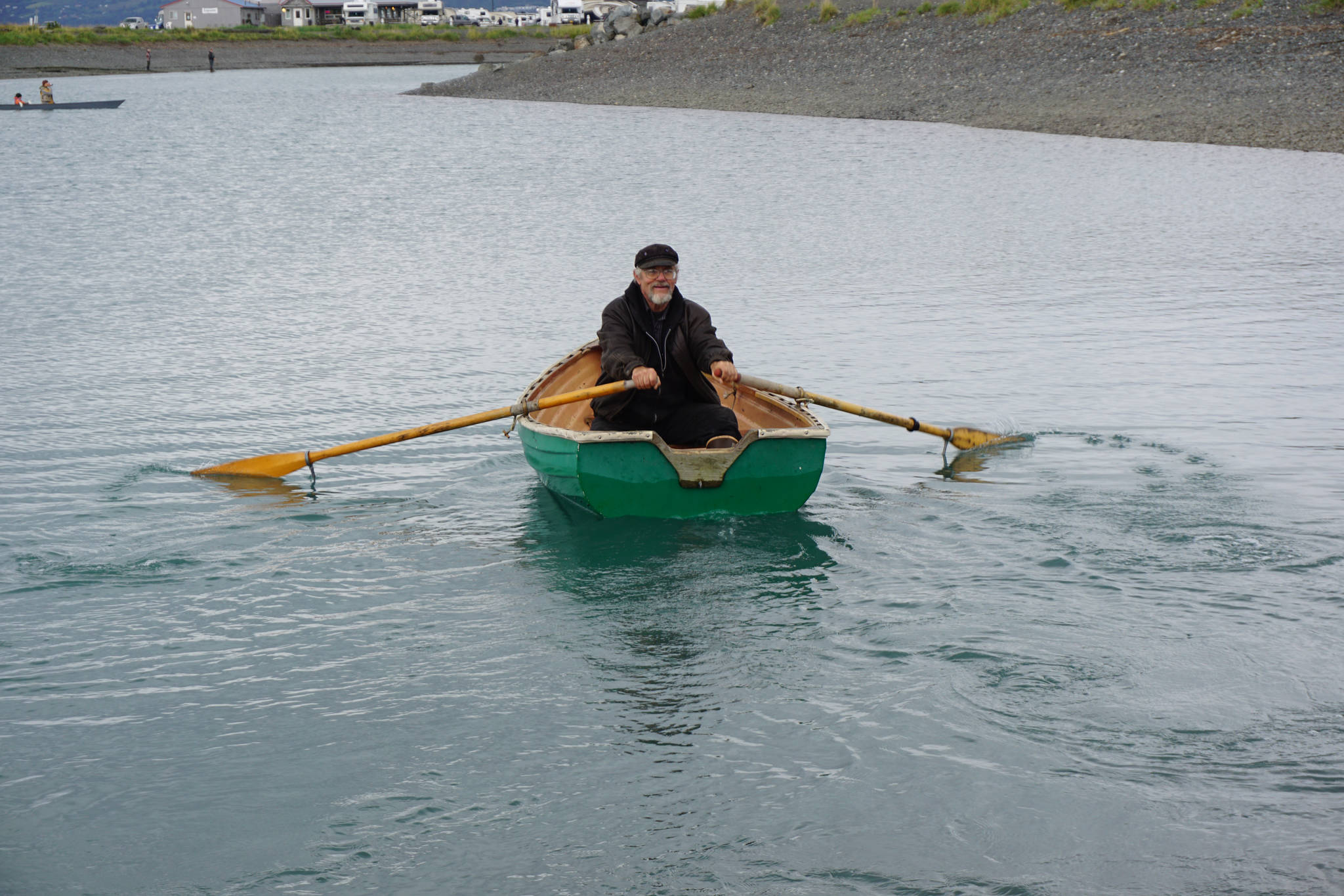 Bumppo Bremicker, president of the Kachemak Bay Wooden Boat Society, rows a boat during the wooden boat festival on Saturday, Sept. 2, 2017 at the Nick Dudiak Fishing Lagoon campground in Homer, Alaska. (Photo by Michael Armstrong, Homer News)