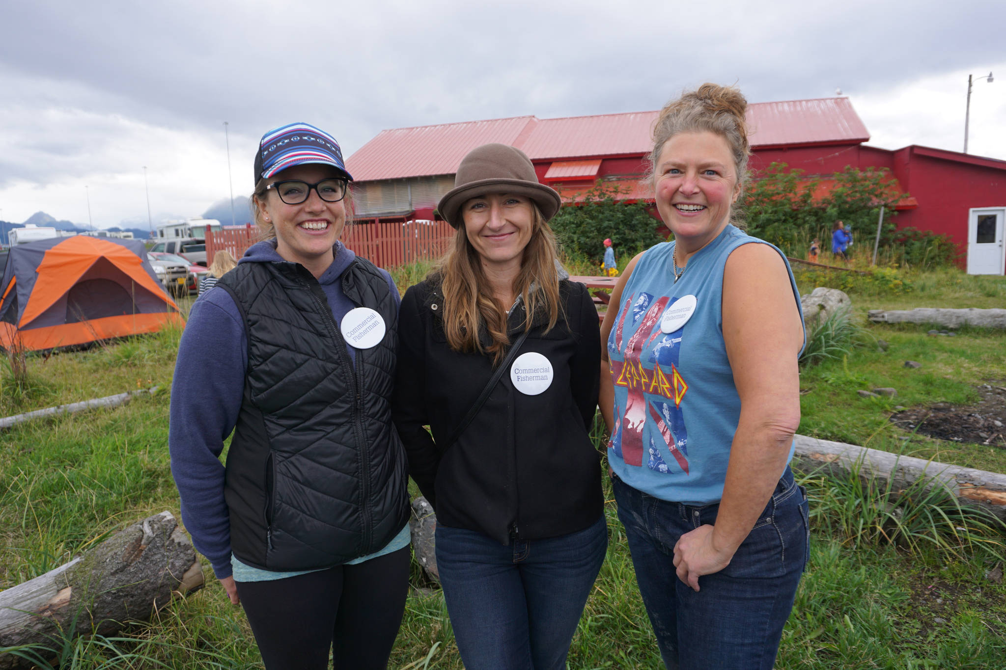 From left to right, Jessie Turner, Lacey Velsko and Renee Alward represent the commercial fishing industry at the North Pacific Fisheries Association Fish Fry last Saturday, Sept. 2, 2017 at the Kachemak Bay Wooden Boat Society festival on the Homer Spit. (Photo by Michael Armstrong, Homer News)