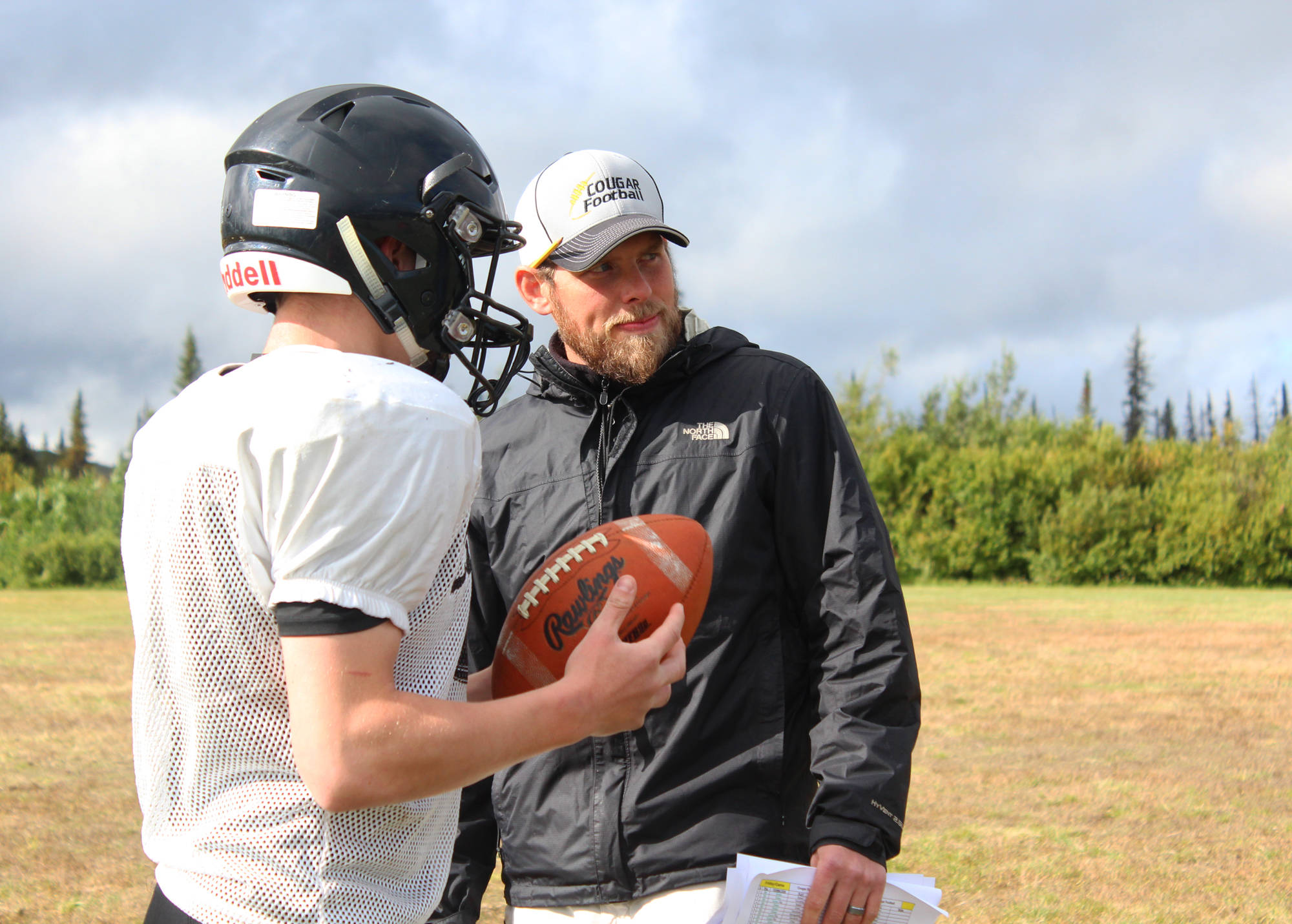Justin Zank, head coach of the Cougars football team, looks on during a practice Friday, Sept. 1, 2017 at McNeil Canyon Elementary in Fritz Creek, Alaska. Zank, with help from the school district and administration, brought the players from Russian Old Believer schools Voznesenka, Razdolna and Kachemak-Selo from an eight-man team to a varsity 11-man program five years ago. (Photo by Megan Pacer/Homer News)