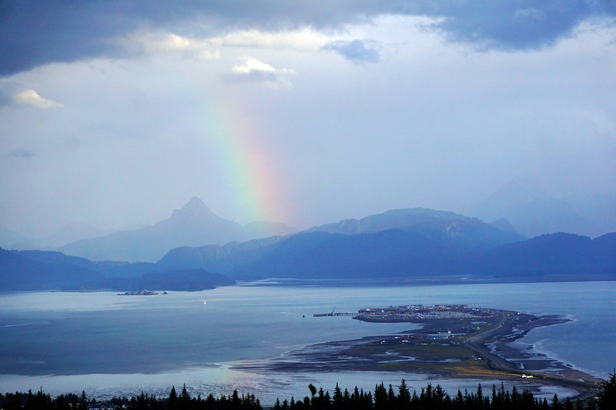 A rainbow appears over Kachemak Bay and Poot Peak on Monday, Sept. 4, 2017 in Homer, Alaska. (Photo by Michael Armstrong/Homer News)