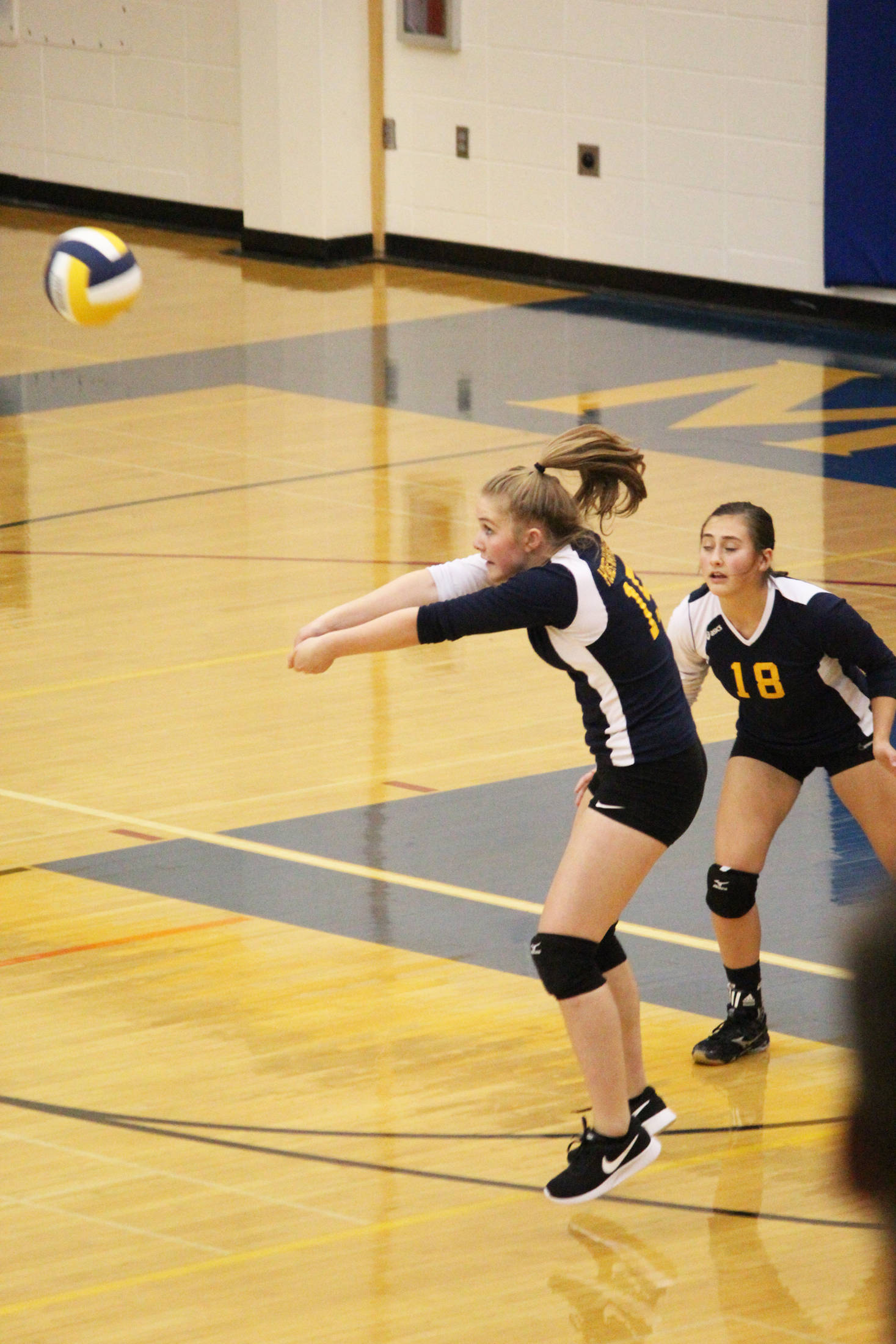 Freshman Paige Jones bumps the ball to a teammate during the Homer varsity volleyball team’s match against Joe Redington Jr/Sr High School on Friday, Sept. 8, 2017 in the Alice Witte Gymnasium in Homer, Alaska. The Mariners the first three sets to beat the Huskies. (Photo by Megan Pacer/Homer News)
