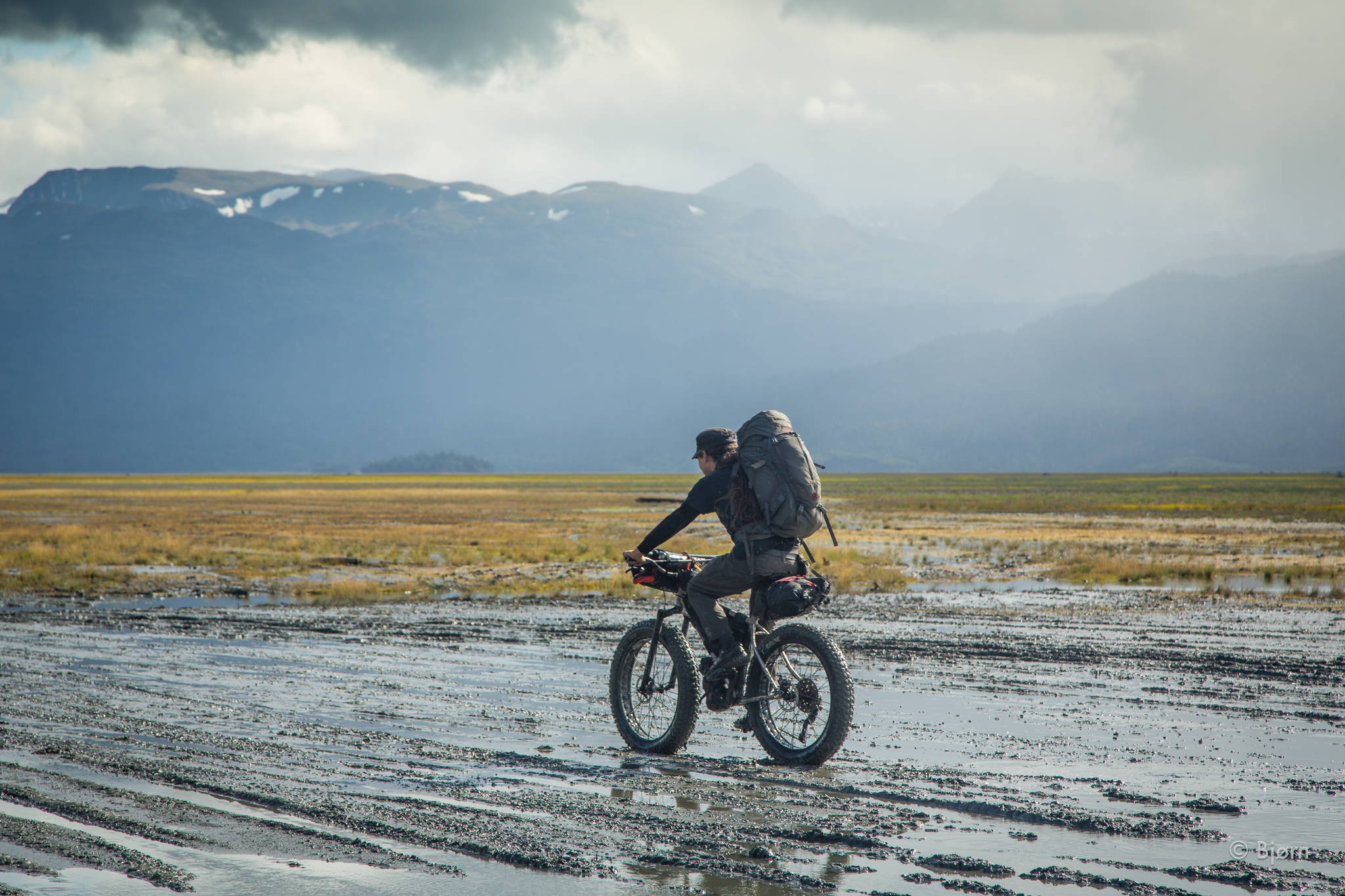 Daniel Countiss attempts to stay upright on his fat-bike while riding in slippery mud at the head of Kachemak Bay. (Photo by Bjørn Olson)