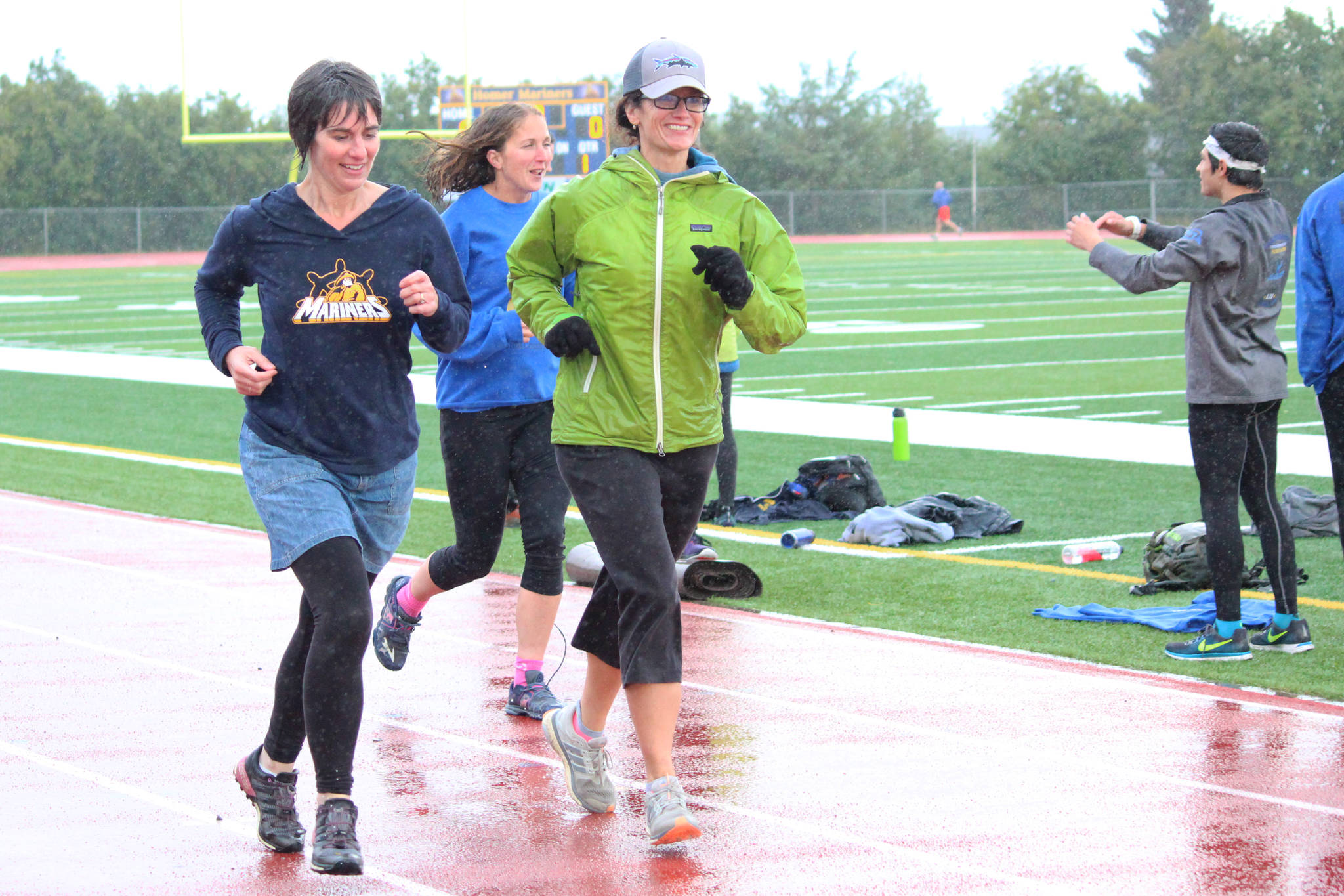 Kathy Beachy (left) runs around the Homer High School track with Saundra Hudson, an active member and cultivator of the running community and a teacher at the high school, during the Mariner Mile on Thursday, Sept. 14, 2017 in Homer, Alaska. Hudson got a concussion this past March when she slipped on the ice while running, and the mile she ran in the fundraising event for the Kachemak Bay Running Club was the her first return to running in six months. (Photo by Megan Pacer/Homer News)