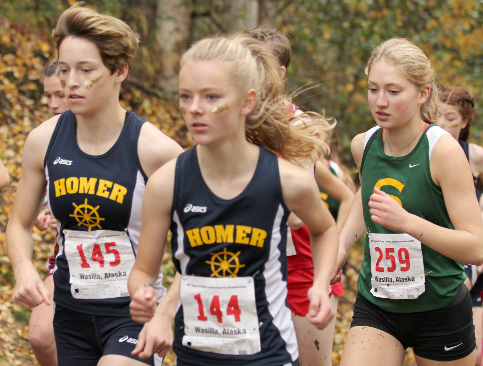 Homer’s Alex Moseley and Brooke Miller and Seward’s Ruby Lindquist jockey for position in the Division II girls race at the Region III Championships on Saturday, Sept. 23, 2017, at the Government Peak Recreation Area. (Photo by Jeremiah Bartz/Frontiersman)