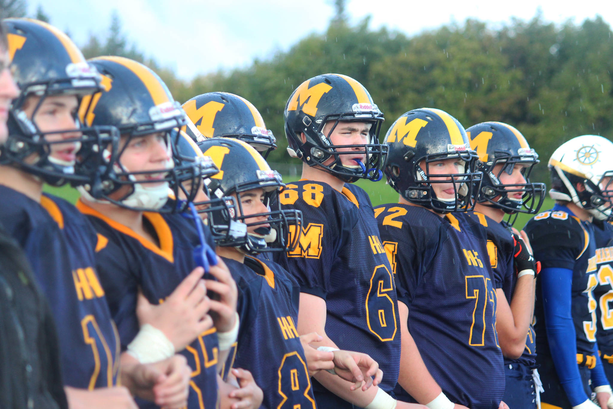 Members of the Homer Mariners varsity football team watch the start of their game against the Head of the Bay Cougars on Friday, Sept. 29, 2017 from the sidelines of the Mariner field in Homer, Alaska, The Mariners prevailed 53-0. (Photo by Megan Pacer/Homer News)