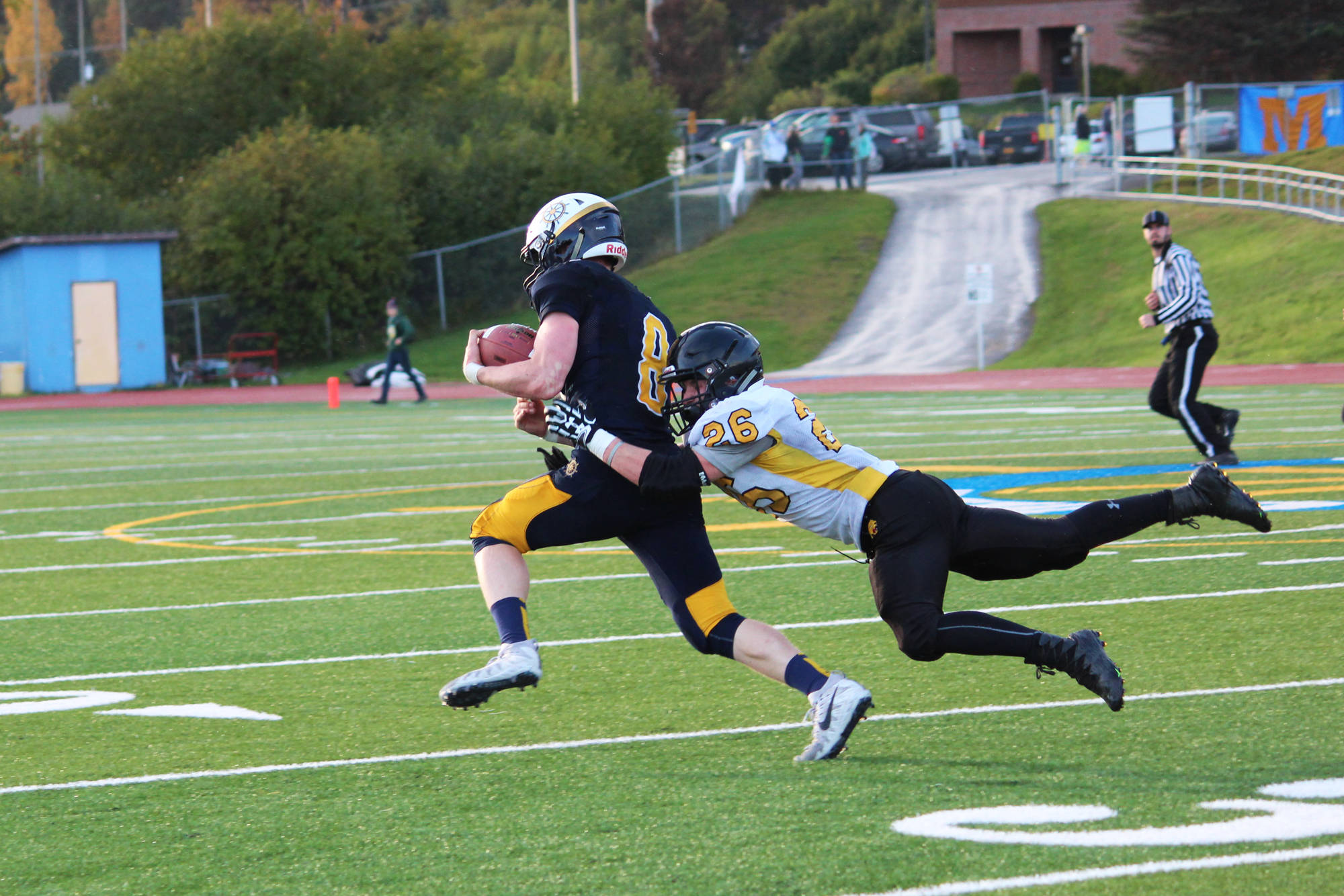 Senior Cougars player David Sanarov tackles Homer Mariners quarterback Teddy Croft during their game Friday, Sept. 29, 2017 at the Mariner field in Homer, Alaska. Homer topped the Cougars 53-0 in the last game for the Head of the Bay team made up of Voznesenka, Razdolna and Kachemak-Selo. (Photo by Megan Pacer/Homer News)