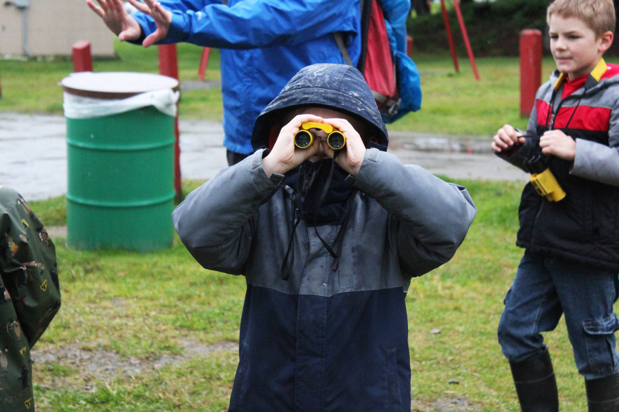 Tristan Alward tests out a pair of binoculars before a field trip to the Beluga Slough on Thursday, Sept. 28, 2017 in Homer, Alaska. The Center for Alaskan Coastal Studies helped school students from Paul Banks Elementary on the ins and out of the slough and Beluga Lake. (Photo by Megan Pacer/Homer News)
