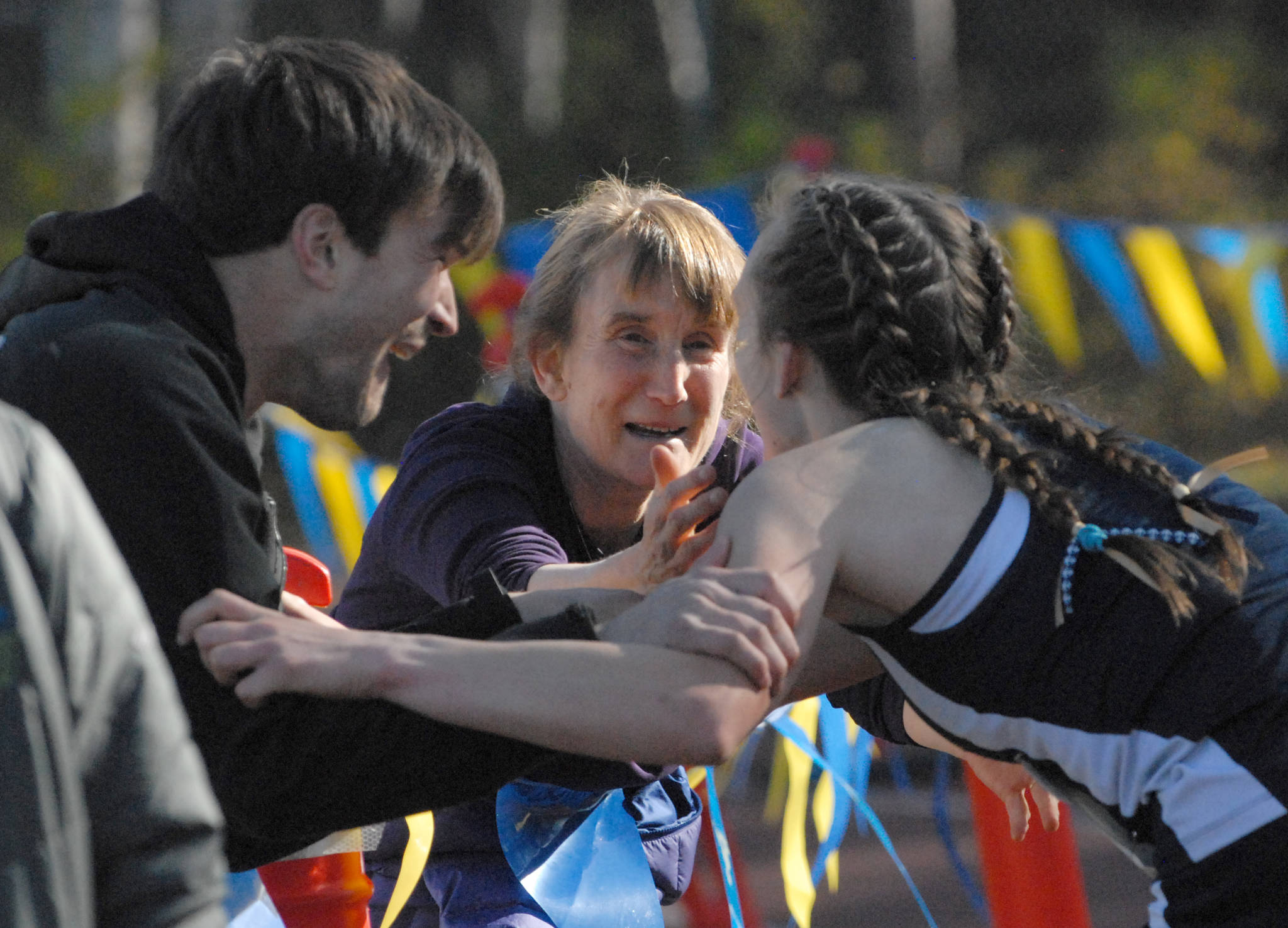 Homer freshman Autumn Daigle celebrates her victory in the Division II girls race with her mom, Anne, and brother, Ben, at the ASAA/First National Bank Alaska State Cross Country Championships on Saturday, Sept. 30, 2017 at Bartlett High School in Anchorage, Alaska. (Photo by Matt Tunseth/Chugiak-Eagle River Star)