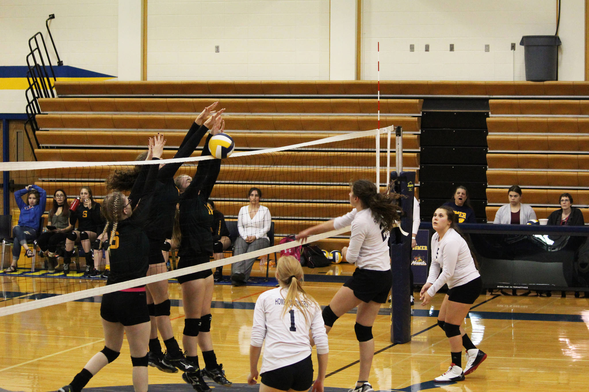 A horde of Seward High School varsity volleyball players block a hit from sophomore Marina Carroll during the Homer Mariners’ home game against the Seahawks on Friday, Sept. 29, 2017 at the Alice Witte Gymnasium in Homer, Alaska. The Mariners fell to the Seahawks, winning one set to the Seahawks’ three sets. (Photo by Megan Pacer/Homer News)