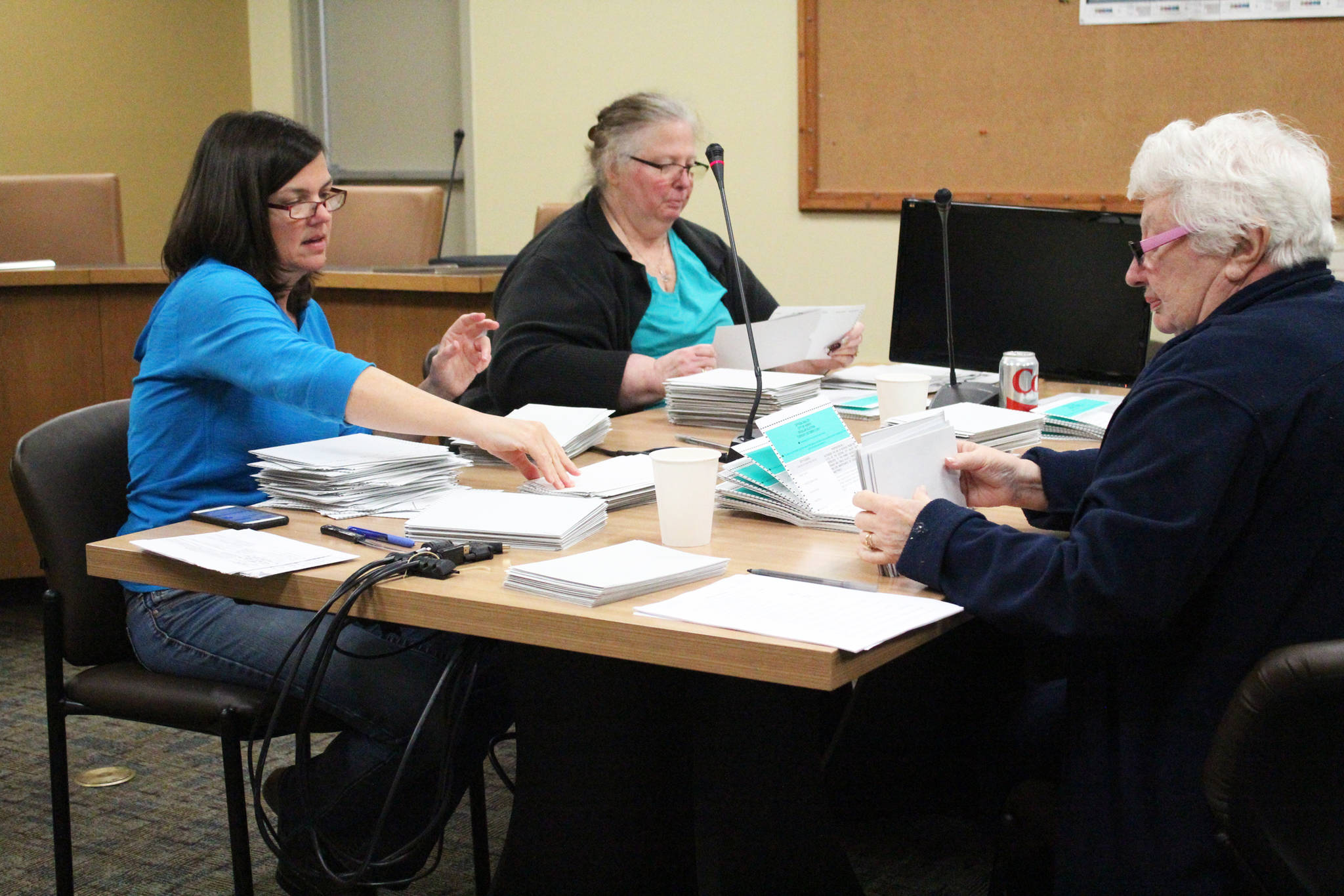 Members of the Homer canvass board work to certify the Oct. 3 election on Friday, Oct. 6, 2017 at Homer City Hall in Homer, Alaska. (Photo by Megan Pacer/Homer News)