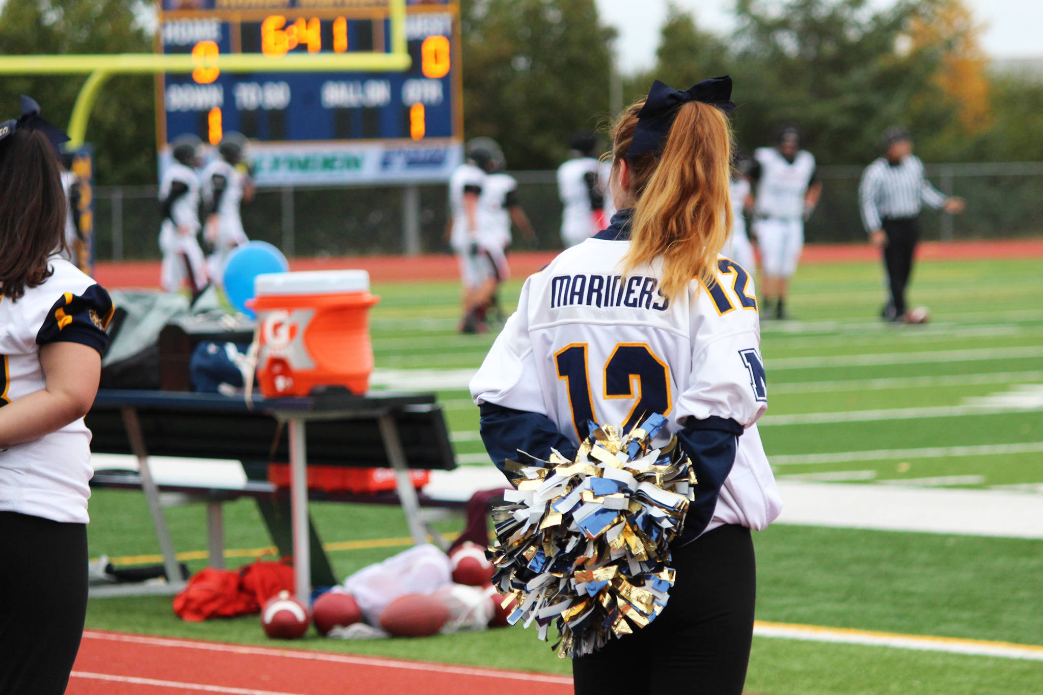 A Homer High School cheerleader watches the Mariners’ game against Ben Eielson High School on Saturday, Oct. 7, 2017 in Homer, Alaska. The Mariners defeated the Ravens 33-21, and will head to the ASAA First National Bowl Series Division III Championship. (Photo by Megan Pacer/Homer News)