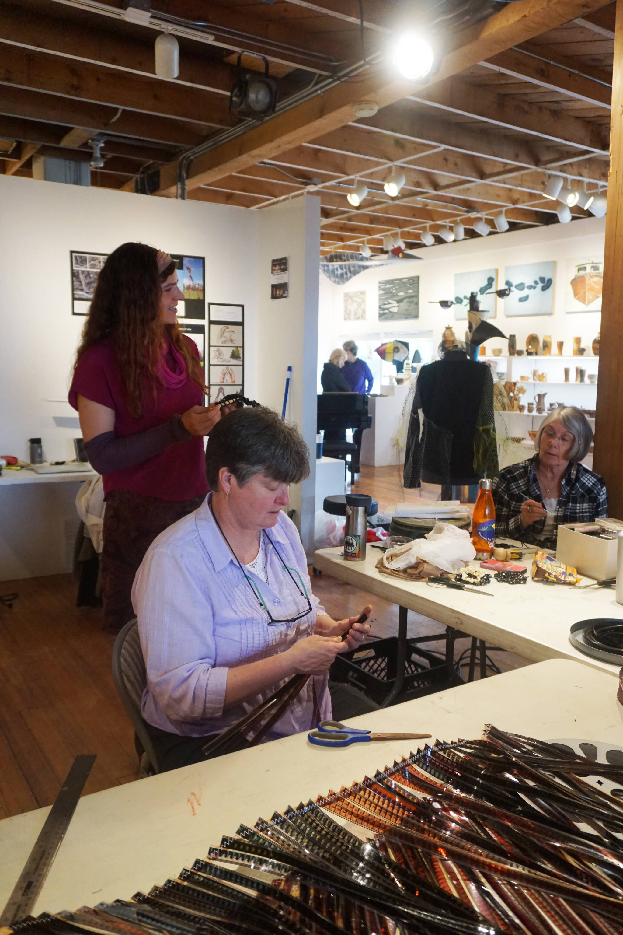 Kayla Spaan, left, and Megan O’Neill, right, work on Wearable Arts pieces Saturday, Oct. 14, 2017 at a workshop with Sheila Wyne at the Bunnell Street Arts Center in Homer, Alaska. Wyne is artist in residence at Bunnell for a residency sponsored by the Homer Fiber Arts Collective. (Photo by Michael Armstrong)