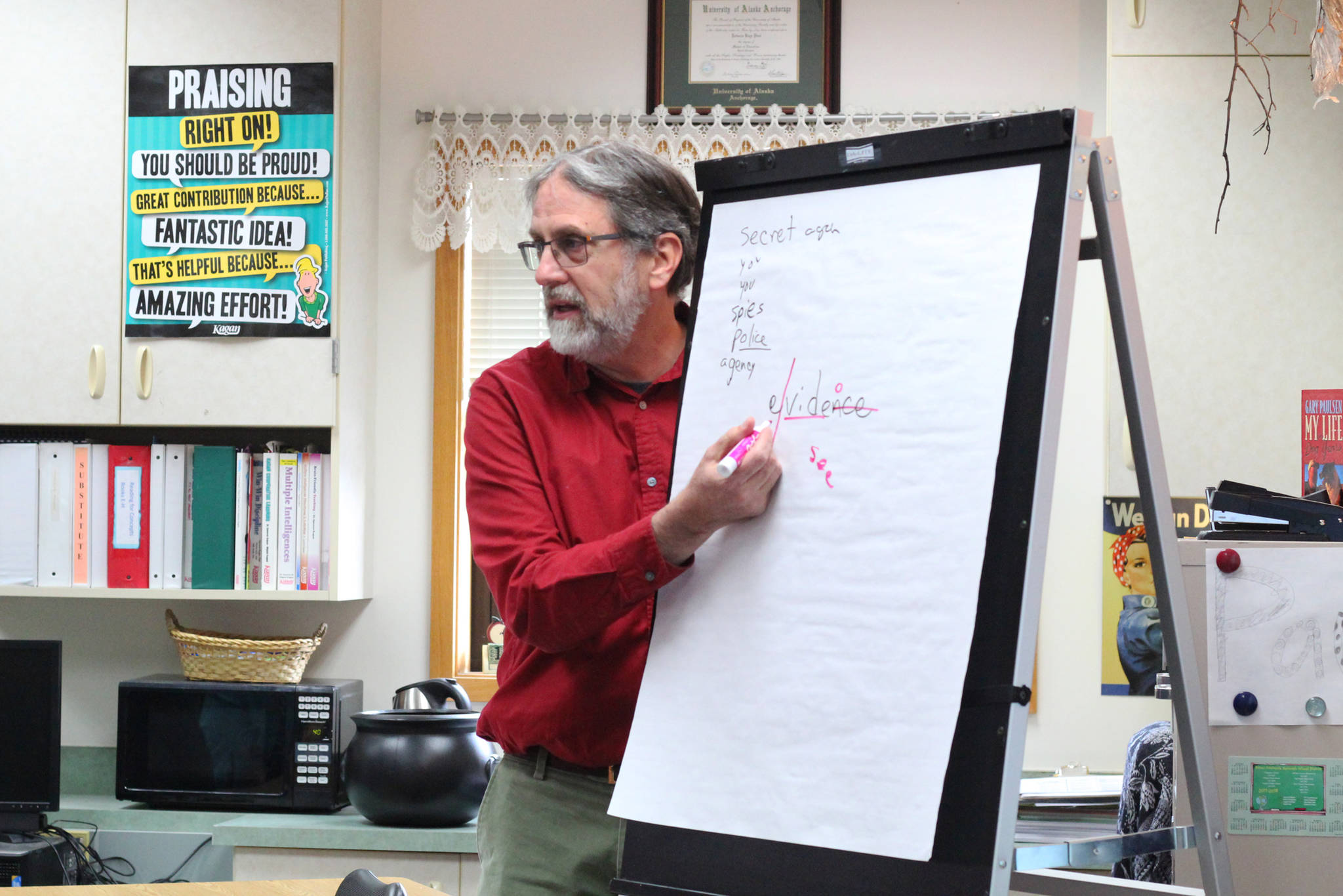 Retired McNeil Canyon teacher Bill Noomah informs students about observation and investigation during a special lesson he taught Thursday, Oct. 19, 2017 to a fifth grade class at West Homer Elementary School in Homer, Alaska. Noomah created the investigation lesson as a way to teach students about Veterans Day and how to primary sources based on a collection from the Library of Congress. (Photo by Megan Pacer/Homer News)