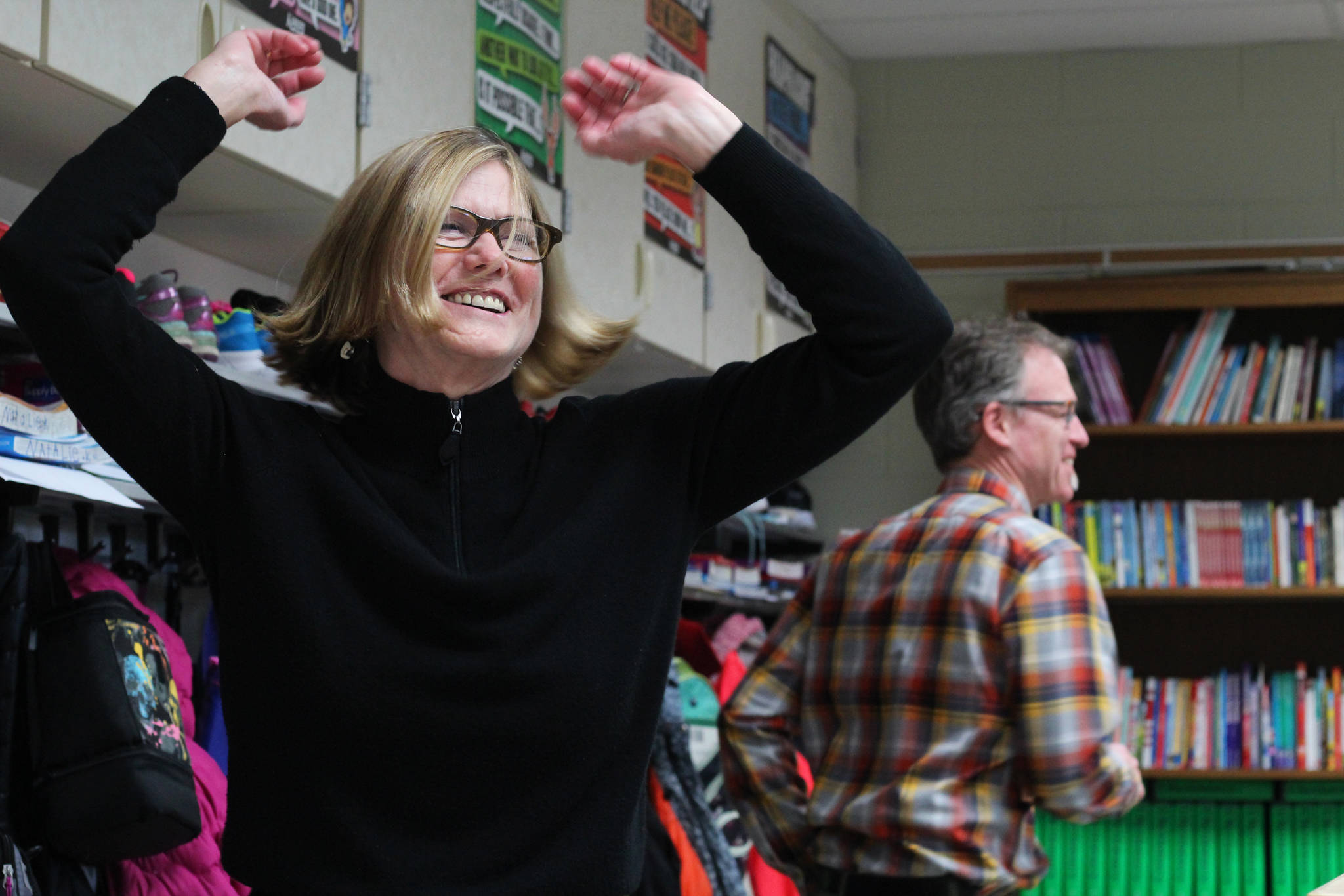 Karen Lloyd, director of the Veterans History Project at the Library of Congress in Washington, D.C., dances the hokey pokey along with West Homer Elementary Principal Eric Waltenbaugh (background) during a special lesson taught by retired McNeil Canyon teacher Bill Noomah on Thursday, Oct. 19, 2017 at the elementary school in Homer, Alaska. Noomah, whose lesson was created to teach kids about Veterans Day and about using primary sources in research, had the students (and adults) take breaks by getting up and dancing. Lloyd was visiting Alaska from D.C. and came to Homer when she heard Noomah would be presenting his lesson, which is based on a collection from the Veterans History Project. (Photo by Megan Pacer/Homer News)