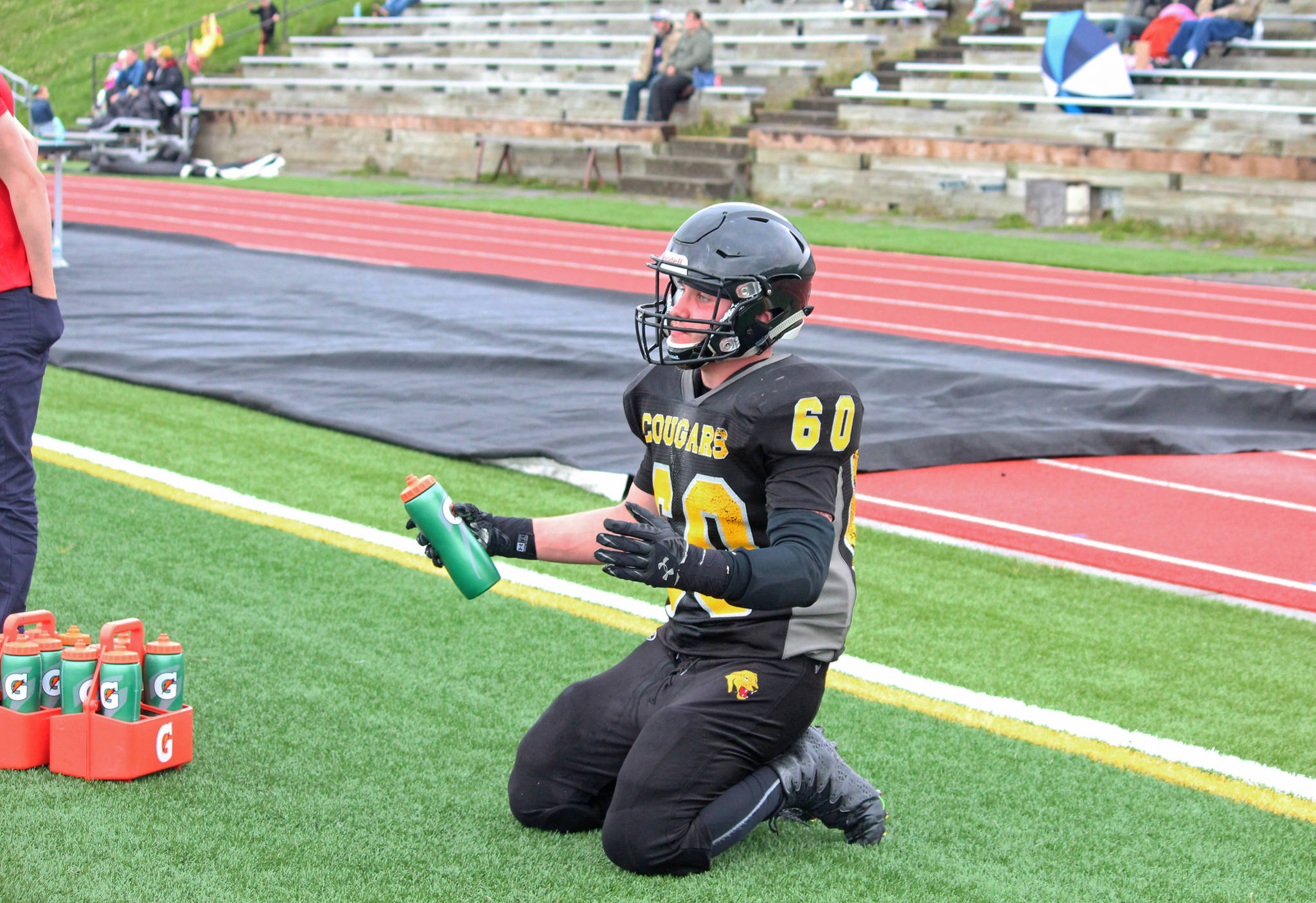 Senior offensive lineman and linebacker David Sanarov raises his hands in frustration watching his team from the sideline while taking a rest during the Cougar football game against Nikiski High School on Saturday, Sept. 2, 2017 in Homer, Alaska. The Cougars were defeated 18-40 in their second game of the season. (Photo by Megan Pacer/Homer News)