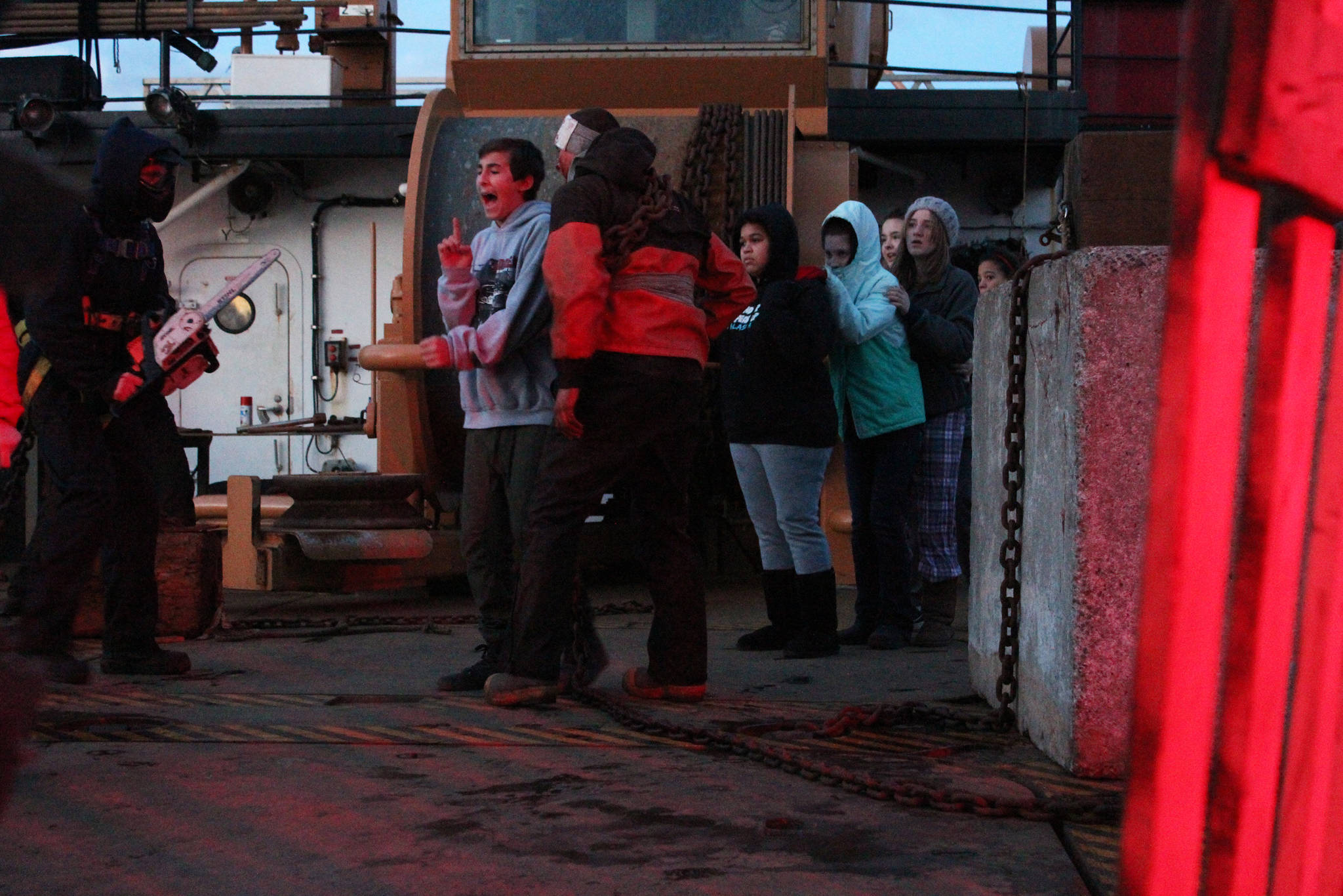 Ben Bergeron scares a group of youngsters passing through the deck of the U.S. Coast Guard Cutter Hickory during this year’s Haunted Hickory event Thursday, Oct. 26, 2017 in Homer, Alaska. Hundreds of residents young and old line up to have the living daylights scared out of them by the Hickory crew and their families, who spend nearly two full days decking out the ship. (Photo by Megan Pacer/Homer News)
