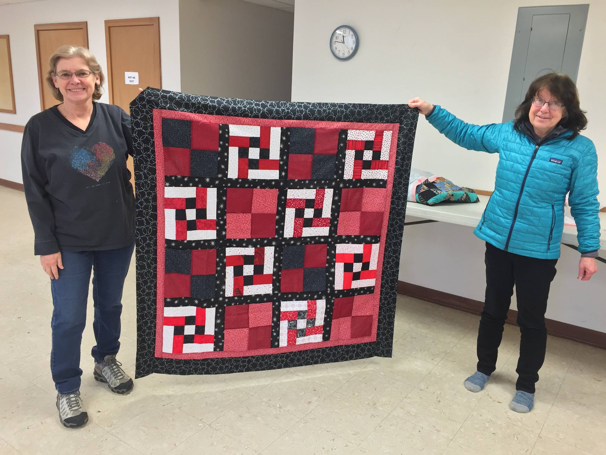 Photo provided Members of the Kachemak Bay Quilters show off one of their quilts.