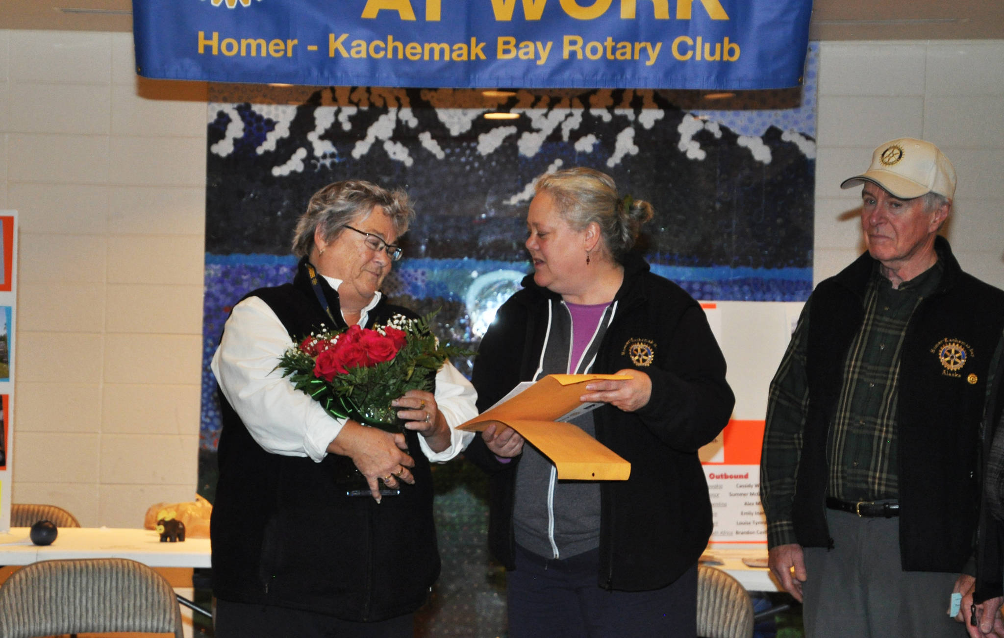Sharon Minsch, left, accepts flowers from Beth Trowbridge, Homer Kachemak Bay Rotary Club President, at this year’s Rotary Health Fair on Saturday, Oct. 28, 2017 at Homer High School in Homer, Alaska. (Photo submitted)