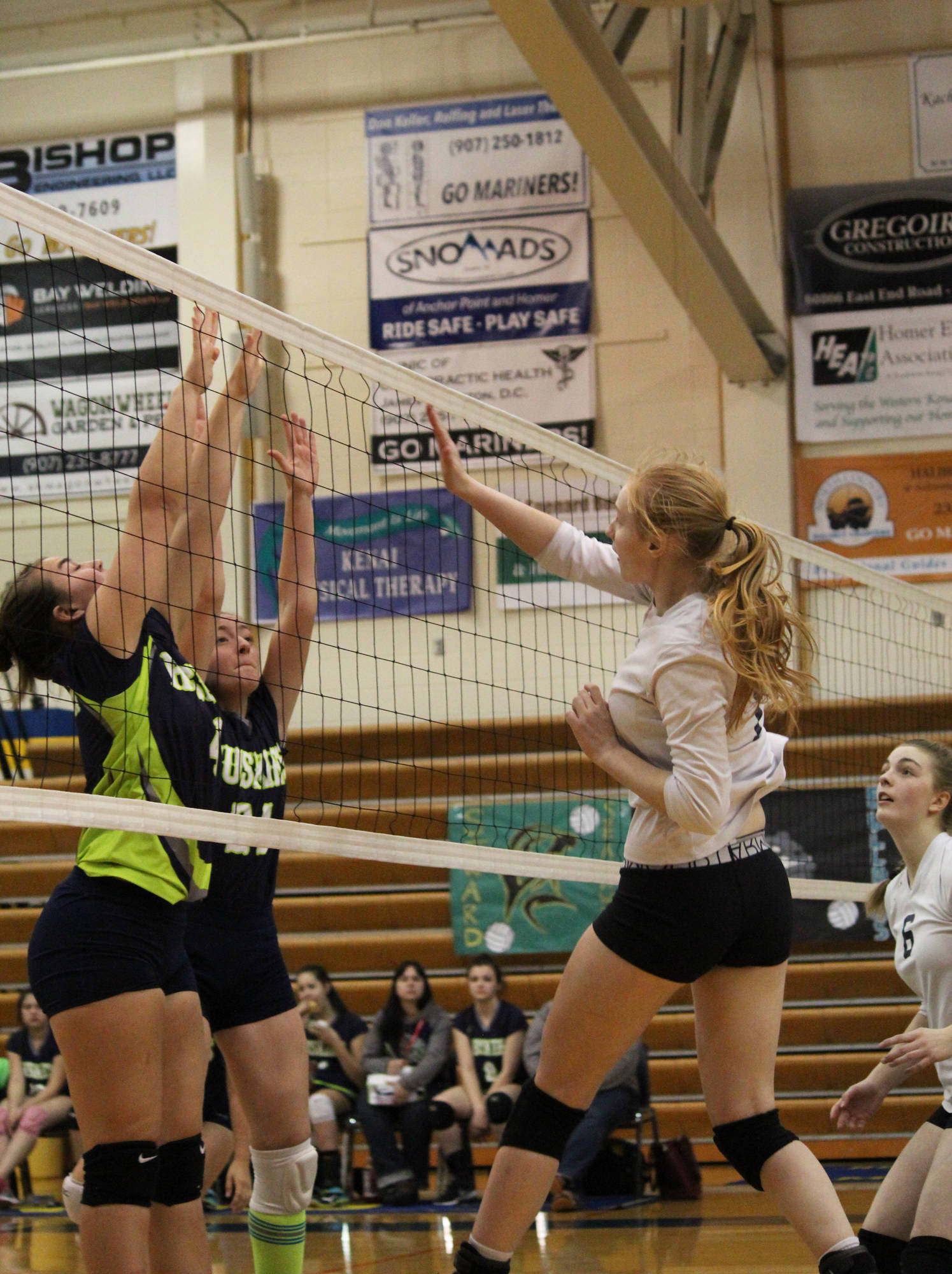 Homer sophomore Kelli Bishop lands after spiking the ball to the Redington Huskies during their match Friday, Nov. 3, 2017 at Homer High School in Homer, Alaska during the 2017 Southcentral Conference Championships. The Mariners took fourth overall. (Photo by Megan Pacer/Homer News)