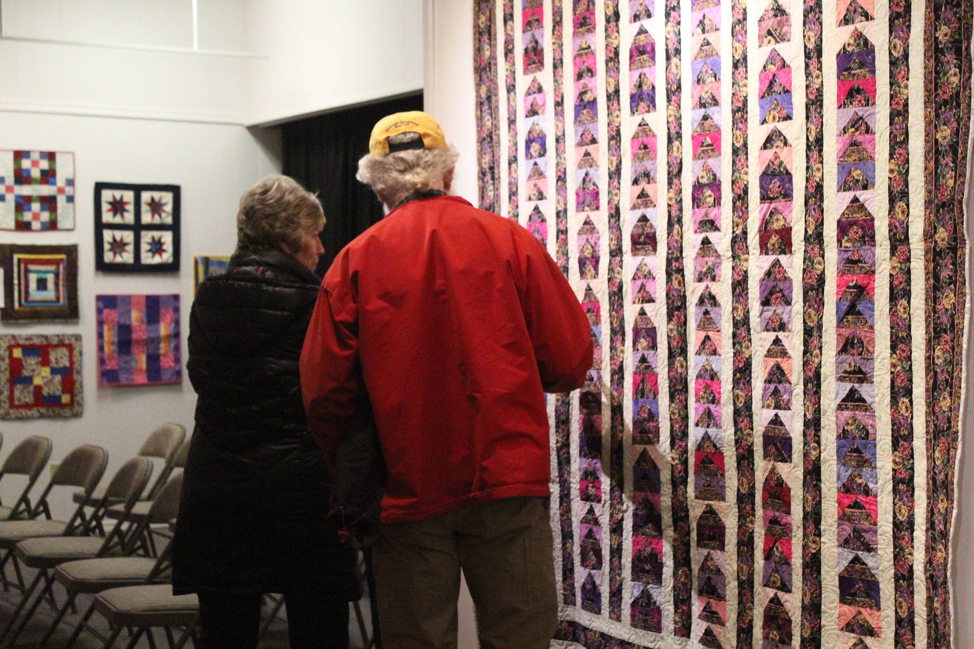 Passersby inspect the work of the Kachemak Bay Quilters during a First Friday exhibit Friday, Nov. 3, 2017 at the Homer Council on the Arts in Homer, Alaska. The quilting group has been around for more than 30 years. (Photo by Megan Pacer/Homer News)