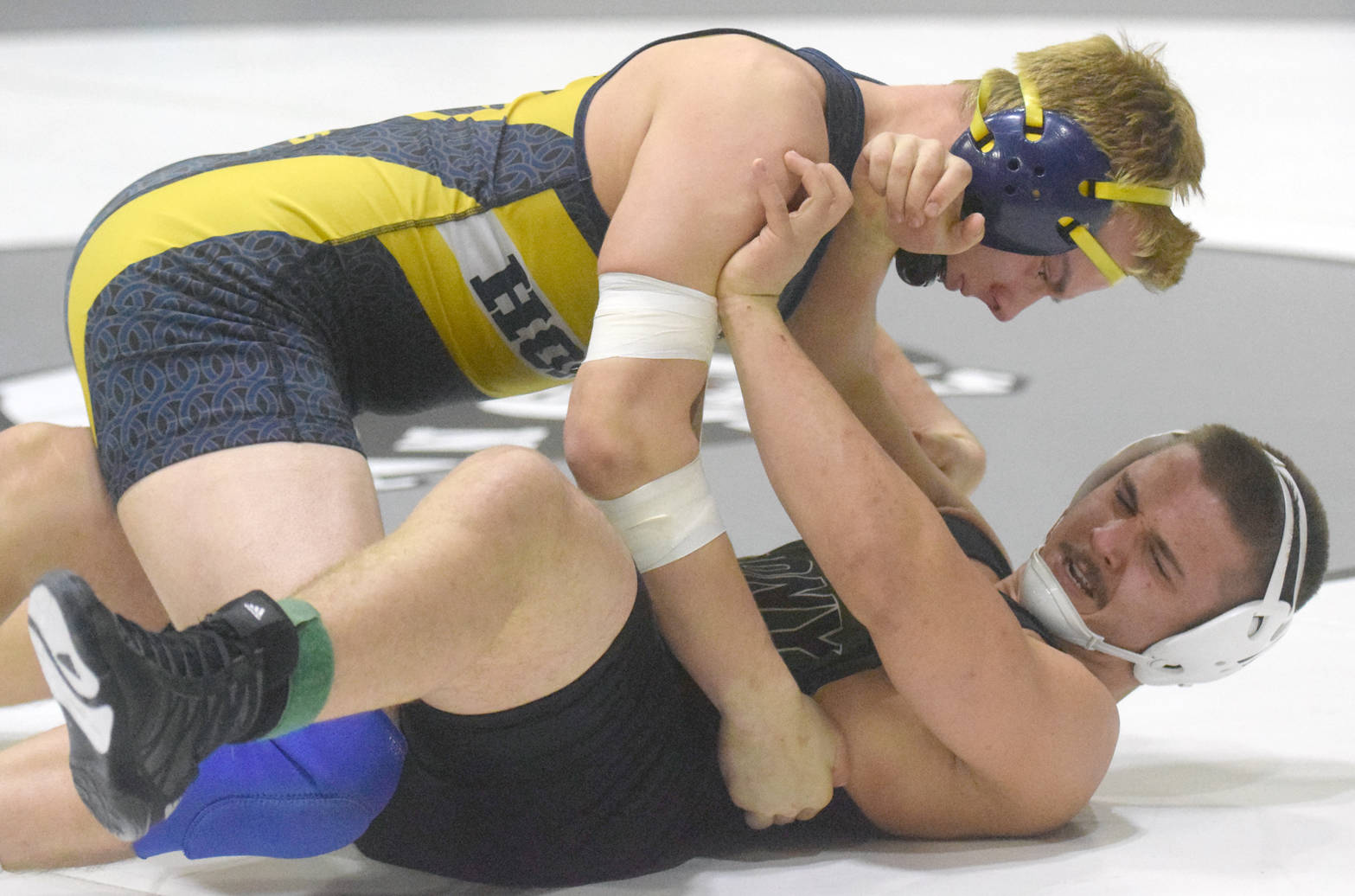 Homer’s Levi King works his way to a pin of Colony’s Simon Ganchenko at 195 pounds Saturday, Nov. 11, 2017, in the championship dual of the Peninsula Duals at Nikiski High School in Nikiski, Alaska. (Photo by Jeff Helminiak/Peninsula Clarion)