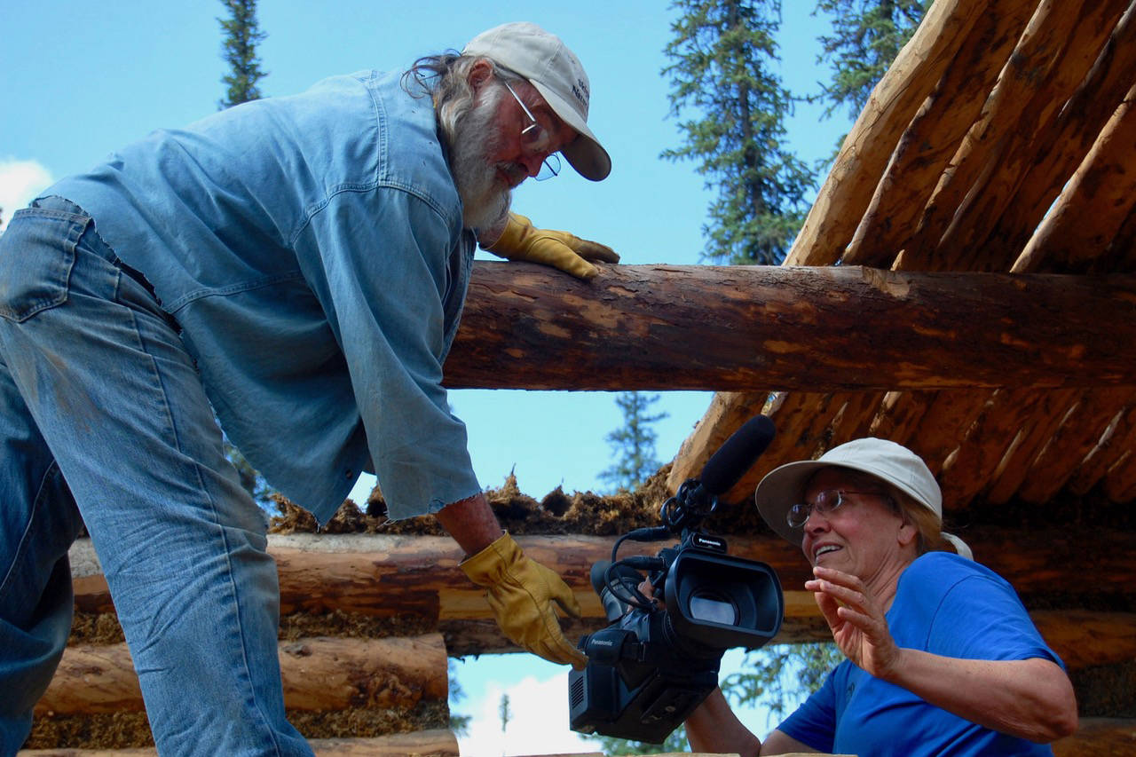 Tom Irons, left, and Jean Aspen, right, film in the summer of 2017 as part of their ongoing chronicle of life at their cabin, Kernwood, on the Chandalar River in the Brooks Range. (Photo provided by Jean Aspen and Tom Irons)